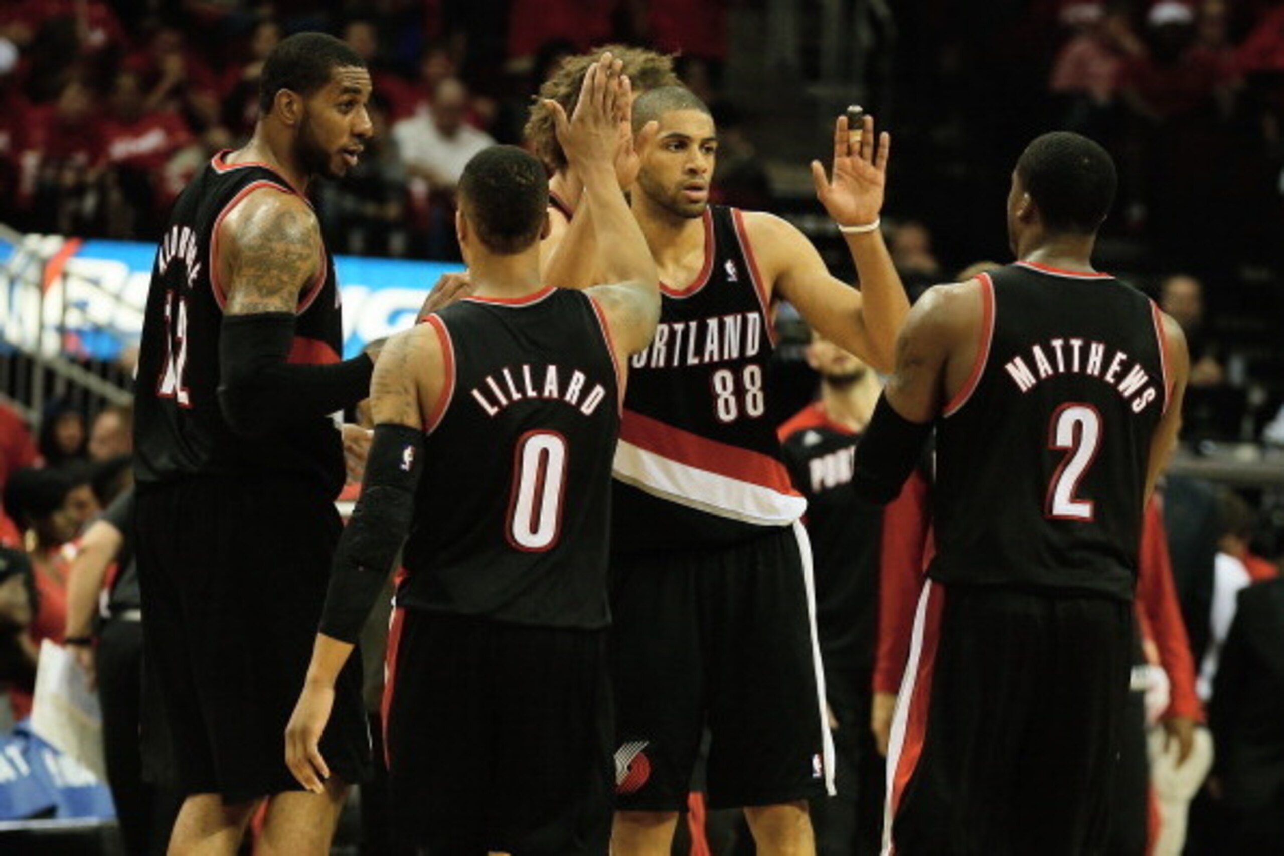 HOUSTON, TX - APRIL 23:  LaMarcus Aldridge #12, Damian Lillard #0, Robin Lopez #42, Nicolas Batum #88 and Wesley Matthews #2 of the Portland Trail Blazers celebrate a play on the court in the second half of the game against the Houston Rockets in Game Two