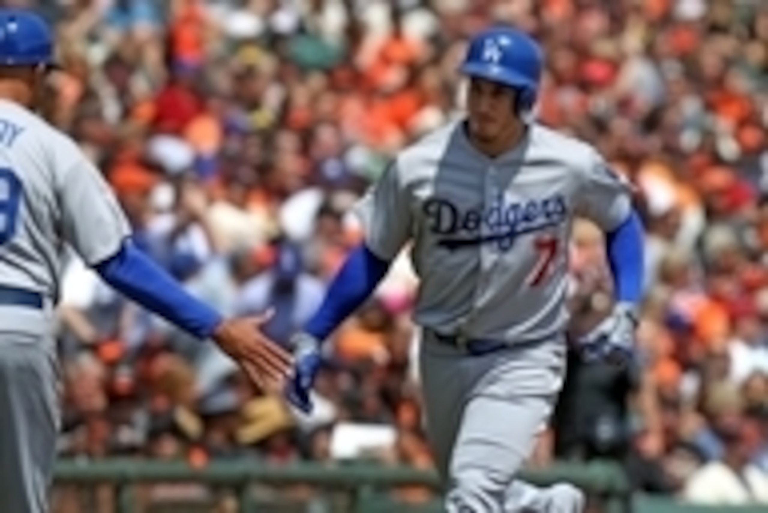 Apr 23, 2015; San Francisco, CA, USA; Los Angeles Dodgers third baseman Alex Guerrero (7) is greeted by third base coach Lorenzo Bundy after hitting a solo home run against the San Francisco Giants in the second inning of their MLB baseball game at AT&T P