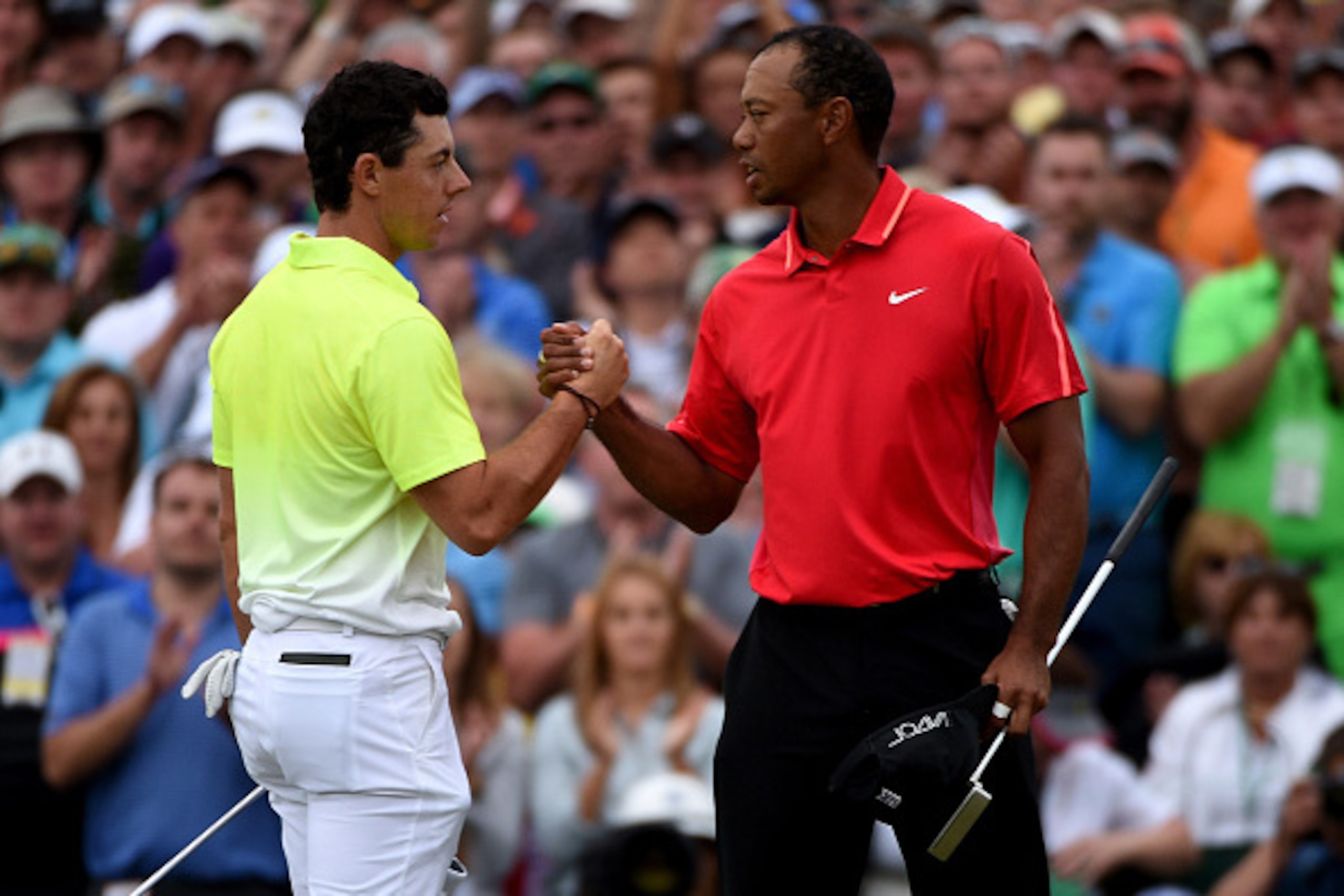 AUGUSTA, GA - APRIL 12:  Rory McIlroy of Northern Ireland and Tiger Woods of the United States shake hands on the 18th green during the final round of the 2015 Masters at Augusta National Golf Club on April 12, 2015 in Augusta, Georgia.  (Photo by Ross Ki