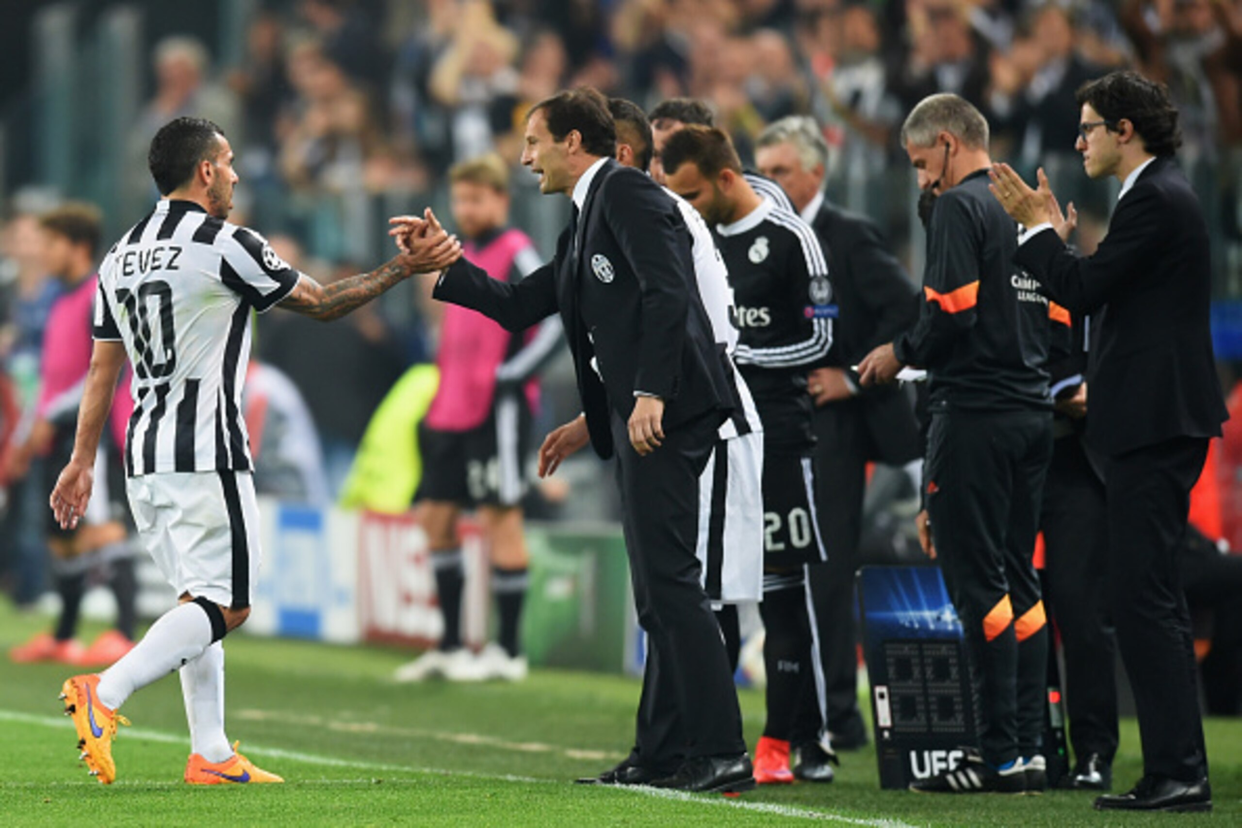 TURIN, ENGLAND - MAY 05:  Carlos Tevez of Juventus shakes hands with Massimiliano Allegri manager of Juventus as he is substituted during the UEFA Champions League semi final first leg match between Juventus and Real Madrid CF at Juventus Arena on May 5, 