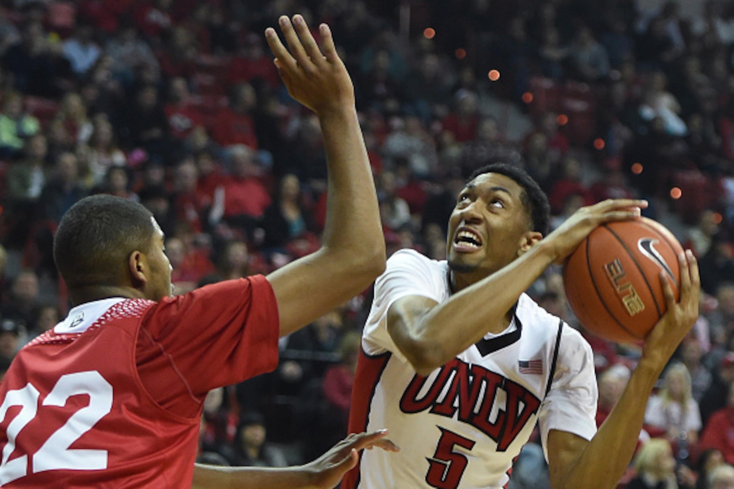 LAS VEGAS, NV - DECEMBER 27:  Christian Wood #5 of the UNLV Rebels drives against Sherron Wilson #22 of the Southern Utah Thunderbirds during their game at the Thomas & Mack Center on December 27, 2014 in Las Vegas, Nevada.  (Photo by Ethan Miller/Getty I