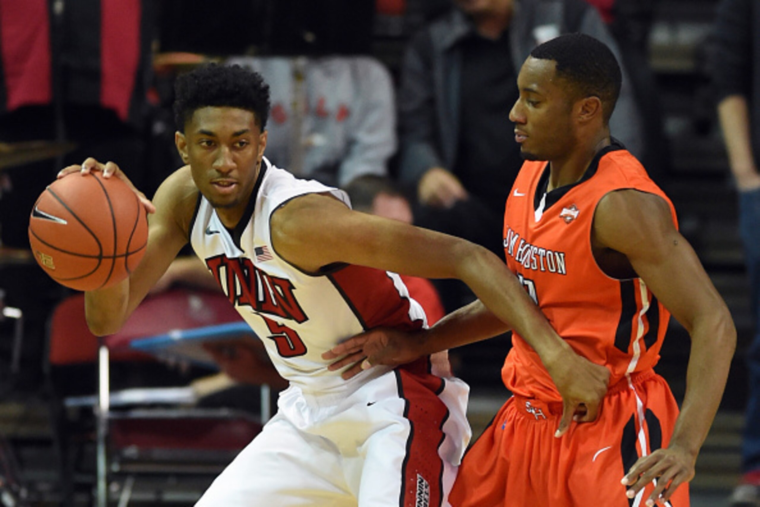 LAS VEGAS, NV - NOVEMBER 16:  Christian Wood #5 of the UNLV Rebels is guarded by DeMarcus Gatlin #11 of the Sam Houston State Bearkats during their game at the Thomas & Mack Center on November 16, 2014 in Las Vegas, Nevada. UNLV won 59-57.  (Photo by Etha