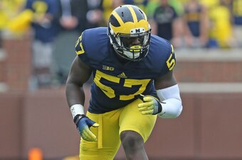 ANN ARBOR, MI - AUGUST 30:  Frank Clark #57 of the Michigan Wolverines looks to make the stop during the second half of the game against the Appalachian State Mountaineers on August 30, 2014 in Ann Arbor, Michigan. The Wolverines defeated the Mountaineers