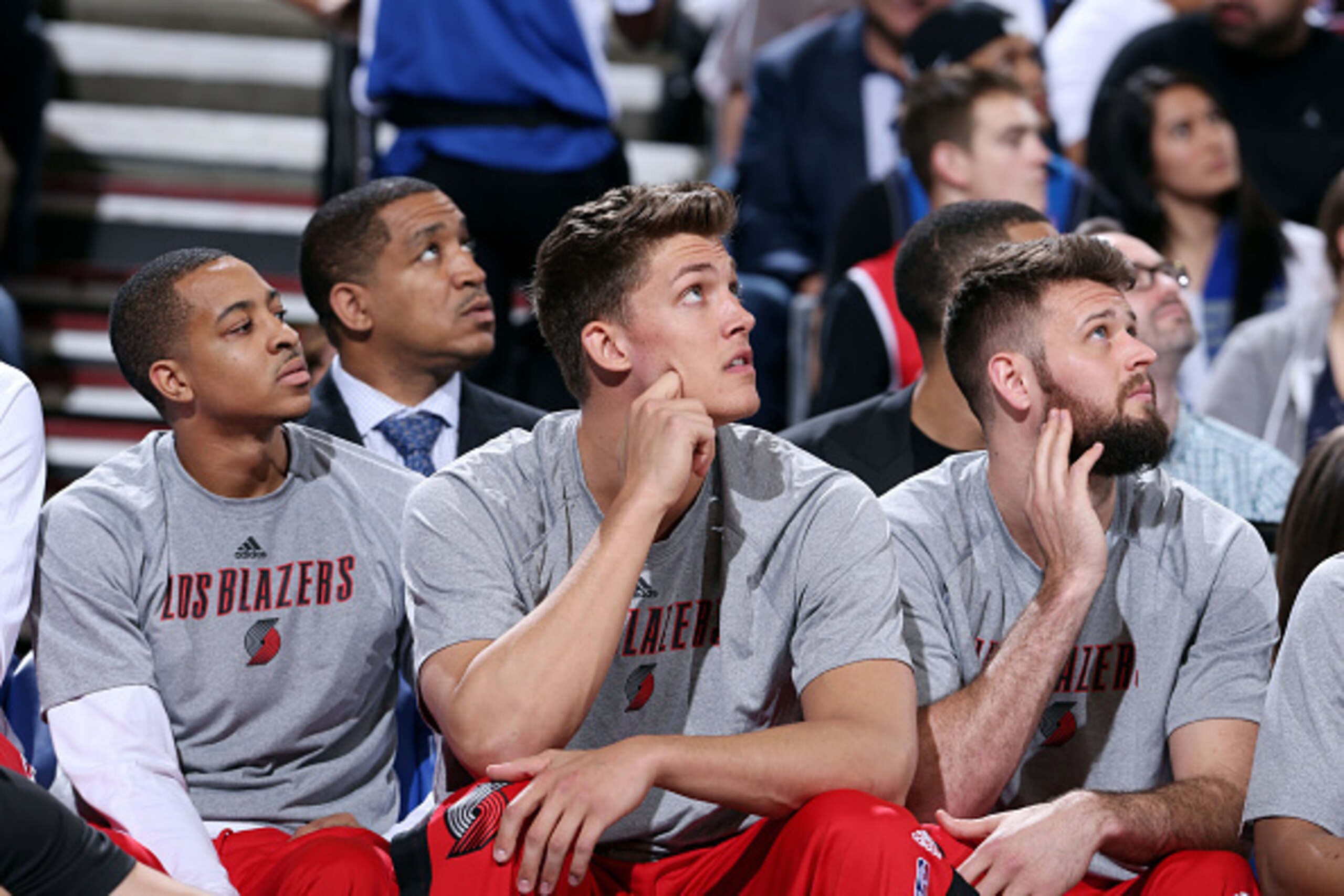 PORTLAND, OR - MARCH 5: C.J. McCollum #3, Meyers Leonard, and Joel Freeland #19 of the Portland Trail Blazers sit on the sideline during a game against the Dallas Mavericks on March 5, 2015 at the Moda Center in Portland, Oregon. NOTE TO USER: User expres