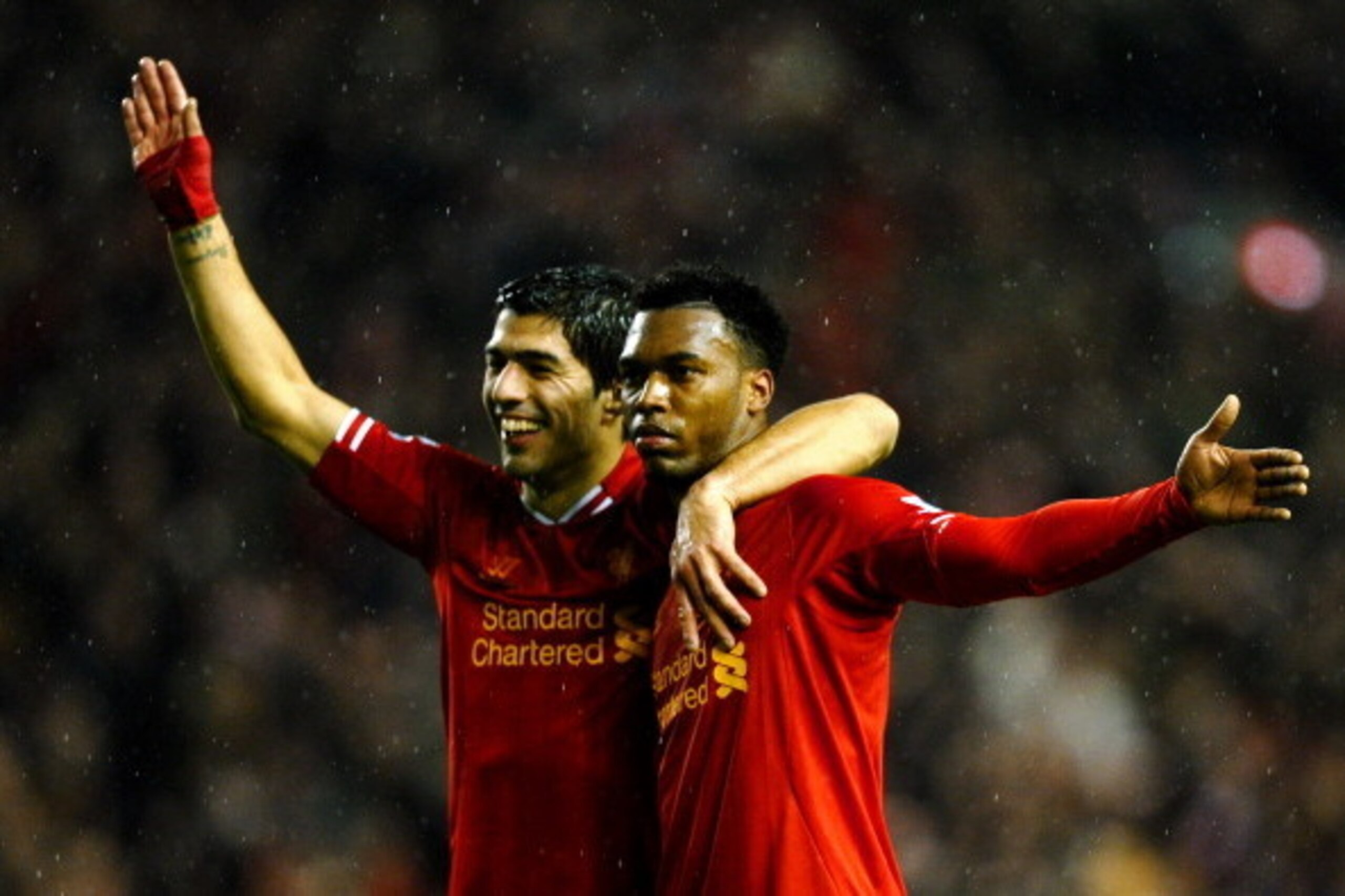 LIVERPOOL, ENGLAND - JANUARY 28:  Daniel Sturridge (R) of Liverpool is congratulated by teammate Luis Suarez (L) after scoring his team's third goal during the Barclays Premier League match between Liverpool and Everton at Anfield on January 28, 2014 in L