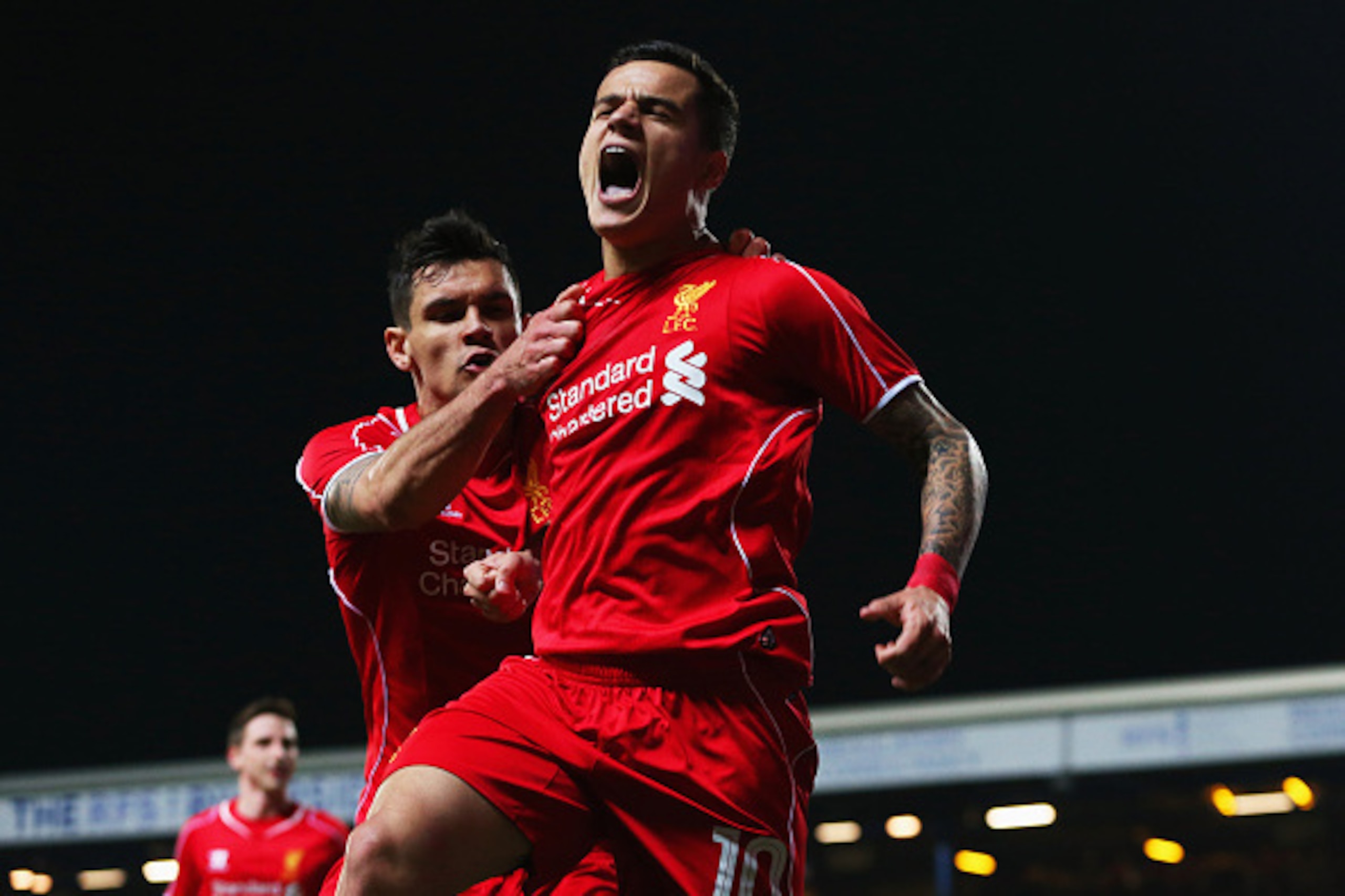 BLACKBURN, ENGLAND - APRIL 08:  Philippe Coutinho of Liverpool (10) celebrates with Dejan Lovren as he scores their first goal during the FA Cup Quarter Final Replay match between Blackburn Rovers and Liverpool at Ewood Park on April 8, 2015 in Blackburn,