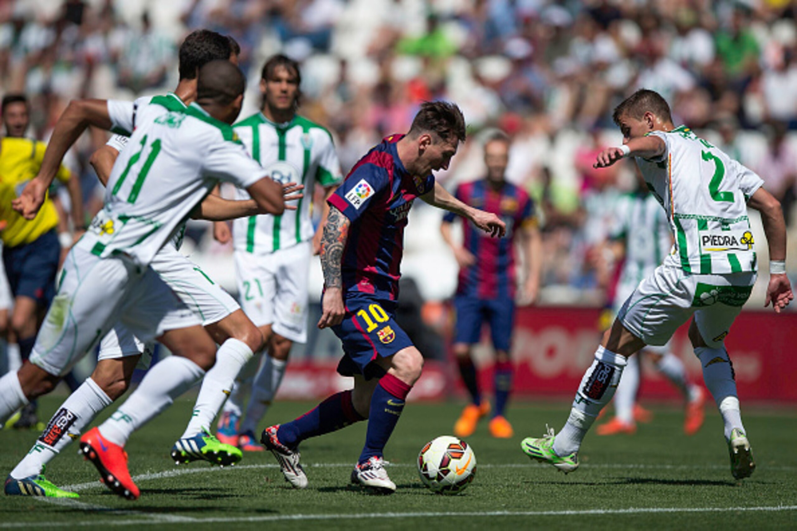 CORDOBA, SPAIN - MAY 02:  Lionel Messi (2ndR) of FC Barcelona competes for the ball with Aleksandar Pantic (R) of Cordoba CF during the La Liga match between Cordoba CF and Barcelona FC at El Arcangel stadium on May 2, 2015 in Cordoba, Spain.  (Photo by G