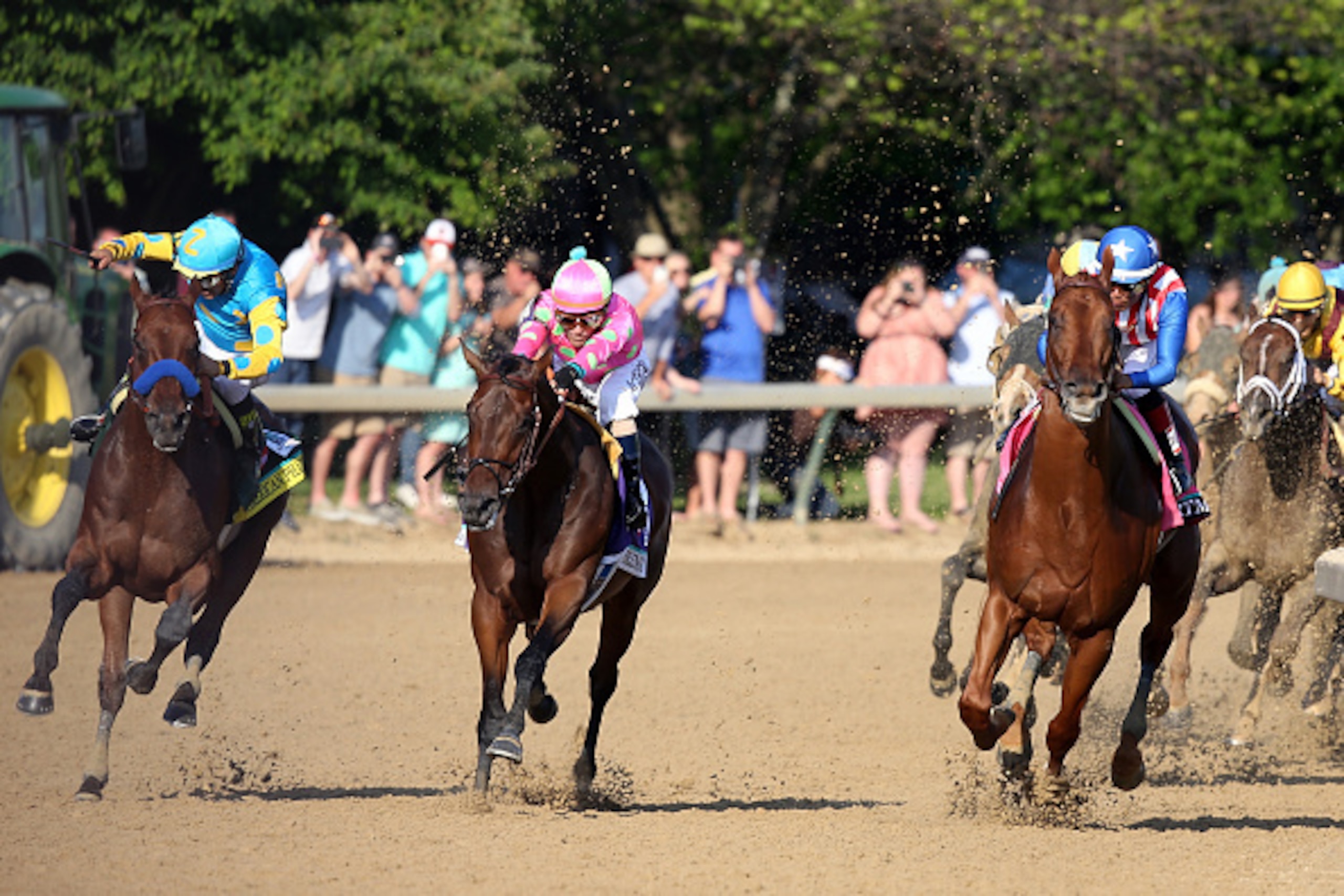 LOUISVILLE, KY - MAY 02:  American Pharoah #18, ridden by Victor Espinoza, races Firing Line #10, ridden by Gary Stevens, out of turn 4 during the 141st running of the Kentucky Derby at Churchill Downs on May 2, 2015 in Louisville, Kentucky.  (Photo by An