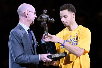 OAKLAND, CA - MAY 05:  Commissioner Adam Silver  presents Stephen Curry #30 of the Golden State Warriors with the 2014-2015 Kia NBA Most Valuable Player Trophy by prior to the start of Game Two of the Western Conference Semifinals of the NBA Playoffs agai