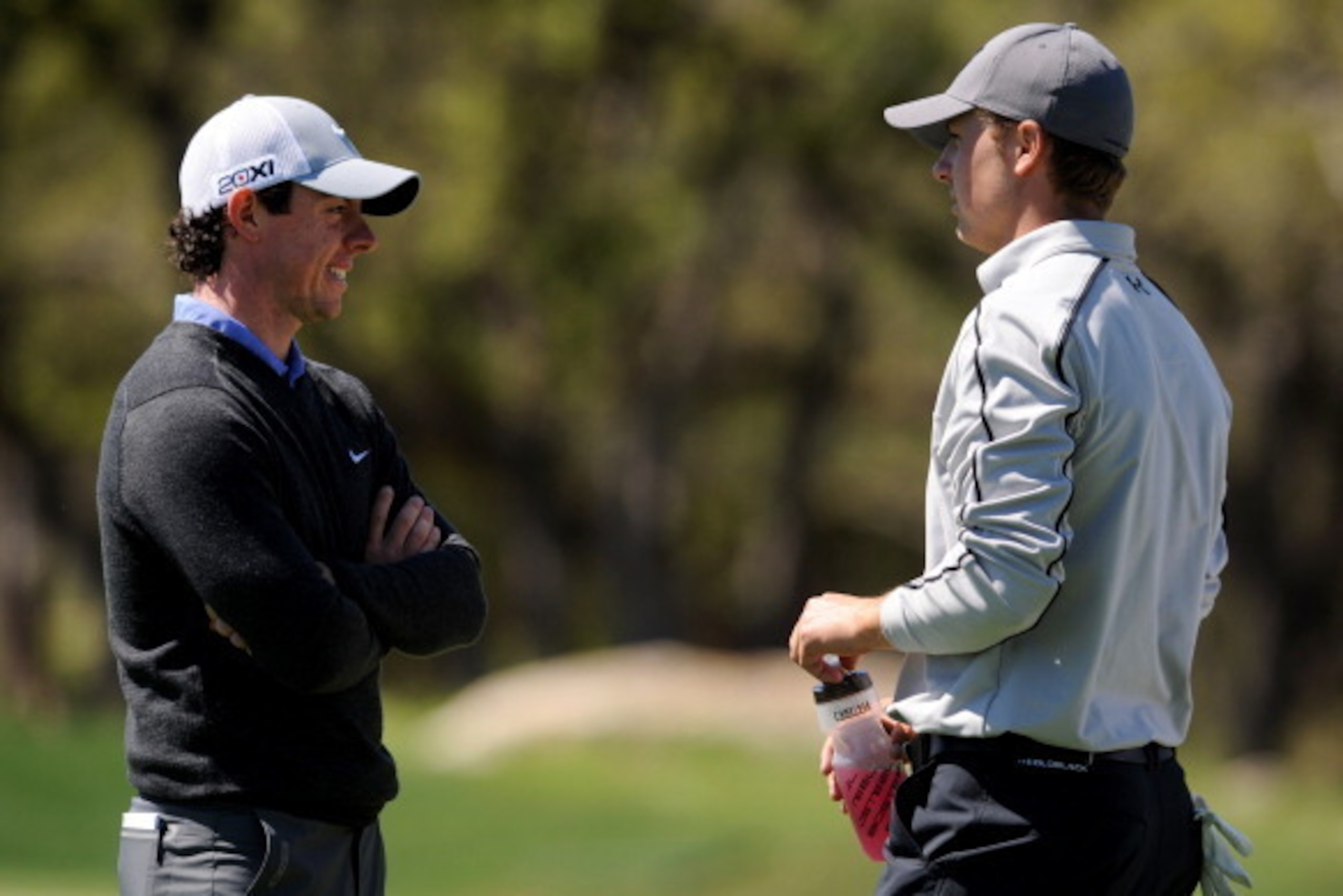 SAN ANTONIO, TX - APRIL 04:  Rory McIlroy of Northern Ireland talks with Jordan Spieth on the 6th hole during the first round of the Valero Texas Open at the AT&T Oaks Course at TPC San Antonio on April 04, 2013 in San Antonio, Texas. (Photo by Steve Dyke