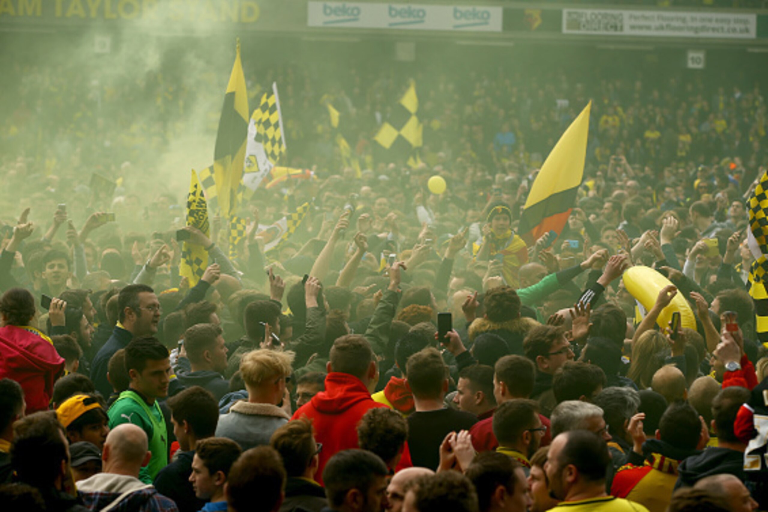 WATFORD, ENGLAND - MAY 02:  Watford fans celebrate promotion on the pitch after the Sky Bet Championship match between Watford and Sheffield Wednesday at Vicarage Road on May 2, 2015 in Watford, England.  (Photo by Richard Heathcote/Getty Images)