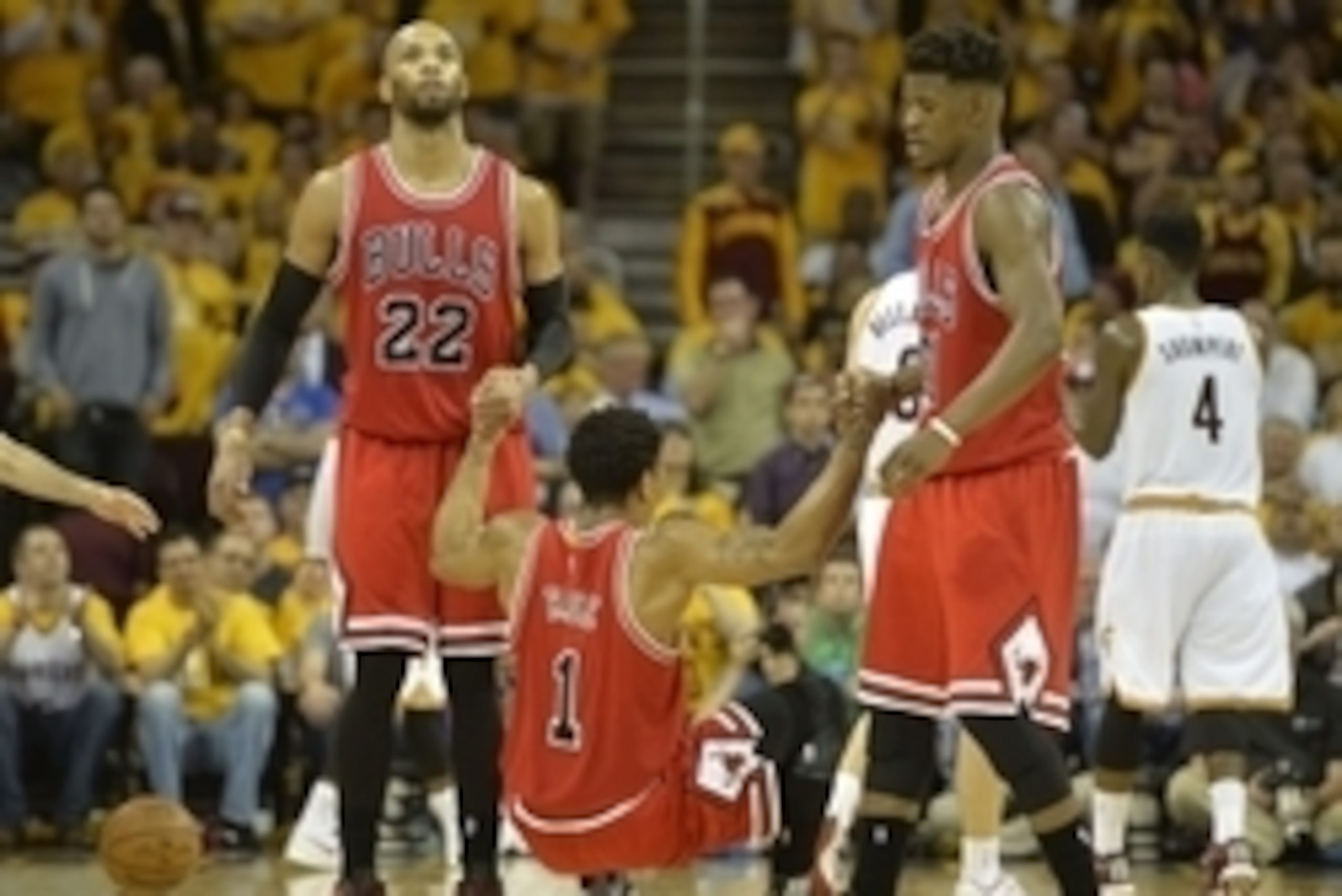 May 4, 2015; Cleveland, OH, USA; Chicago Bulls forward Taj Gibson (22) and guard Jimmy Butler (21) help guard Derrick Rose (1) to his feet in the fourth quarter against the Cleveland Cavaliers in game one of the second round of the NBA Playoffs at Quicken