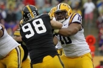 Jan 1, 2014; Tampa, Fl, USA; LSU Tigers offensive tackle La'el Collins (70) blocks as Iowa Hawkeyes defensive lineman Mike Hardy (98) rushes during the first half at Raymond James Stadium. Mandatory Credit: Kim Klement-USA TODAY Sports