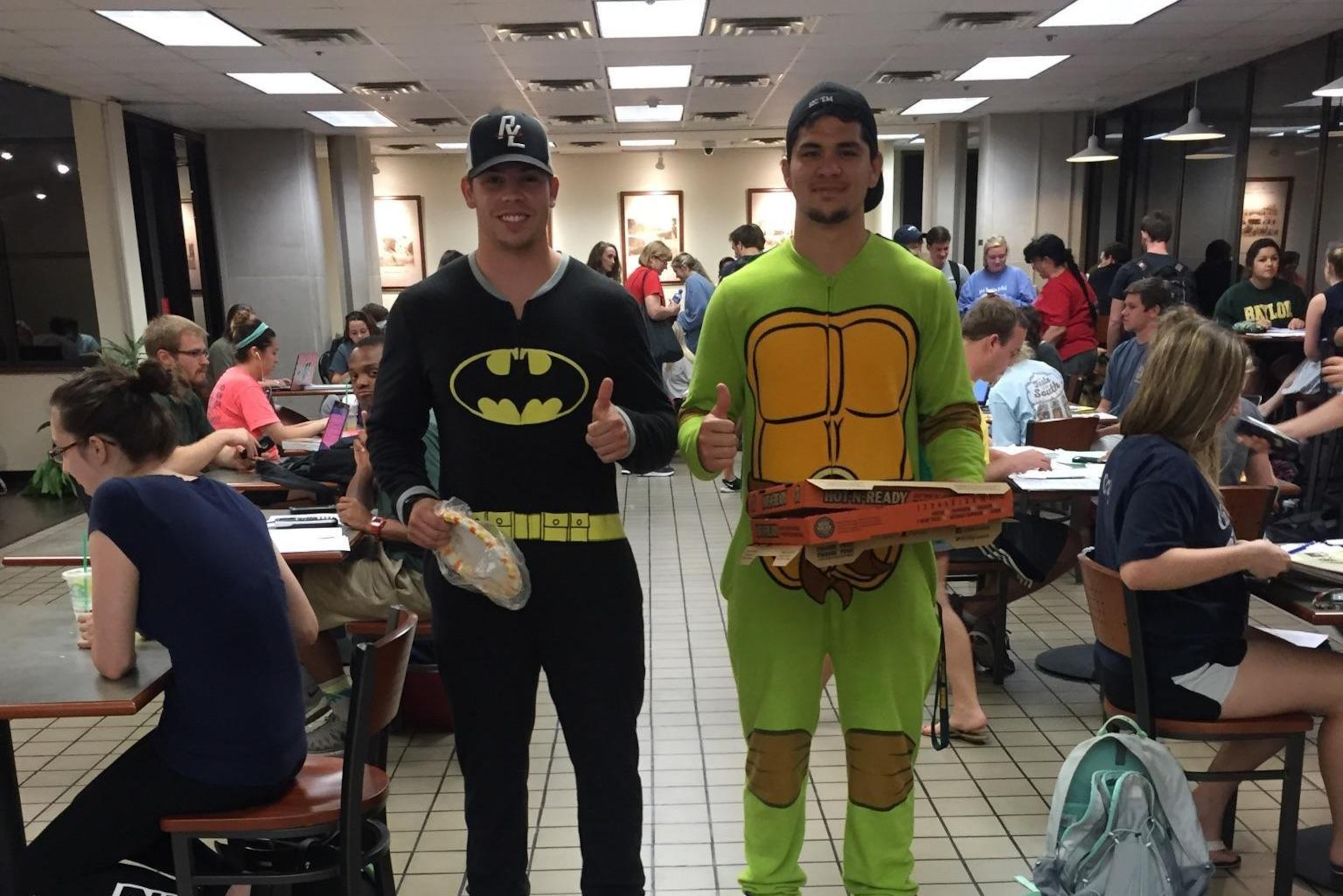 Wyatt Schrepfer and Silas Nacita delivering pizzas