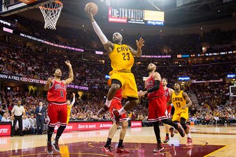 CLEVELAND, OH - MAY 6: LeBron James #23 of the Cleveland Cavaliers goes up for a shot over Derrick Rose #1 and Taj Gibson #22 of the Chicago Bulls in the first half during Game Two in the Eastern Conference Semifinals of the 2015 NBA Playoffs 2015 at Quic