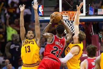 CLEVELAND, OH - MAY 6: Tristan Thompson #13 and Timofey Mozgov #20 of the Cleveland Cavaliers defend against Jimmy Butler #21 of the Chicago Bulls in the first half during Game Two in the Eastern Conference Semifinals of the 2015 NBA Playoffs 2015 at Quic