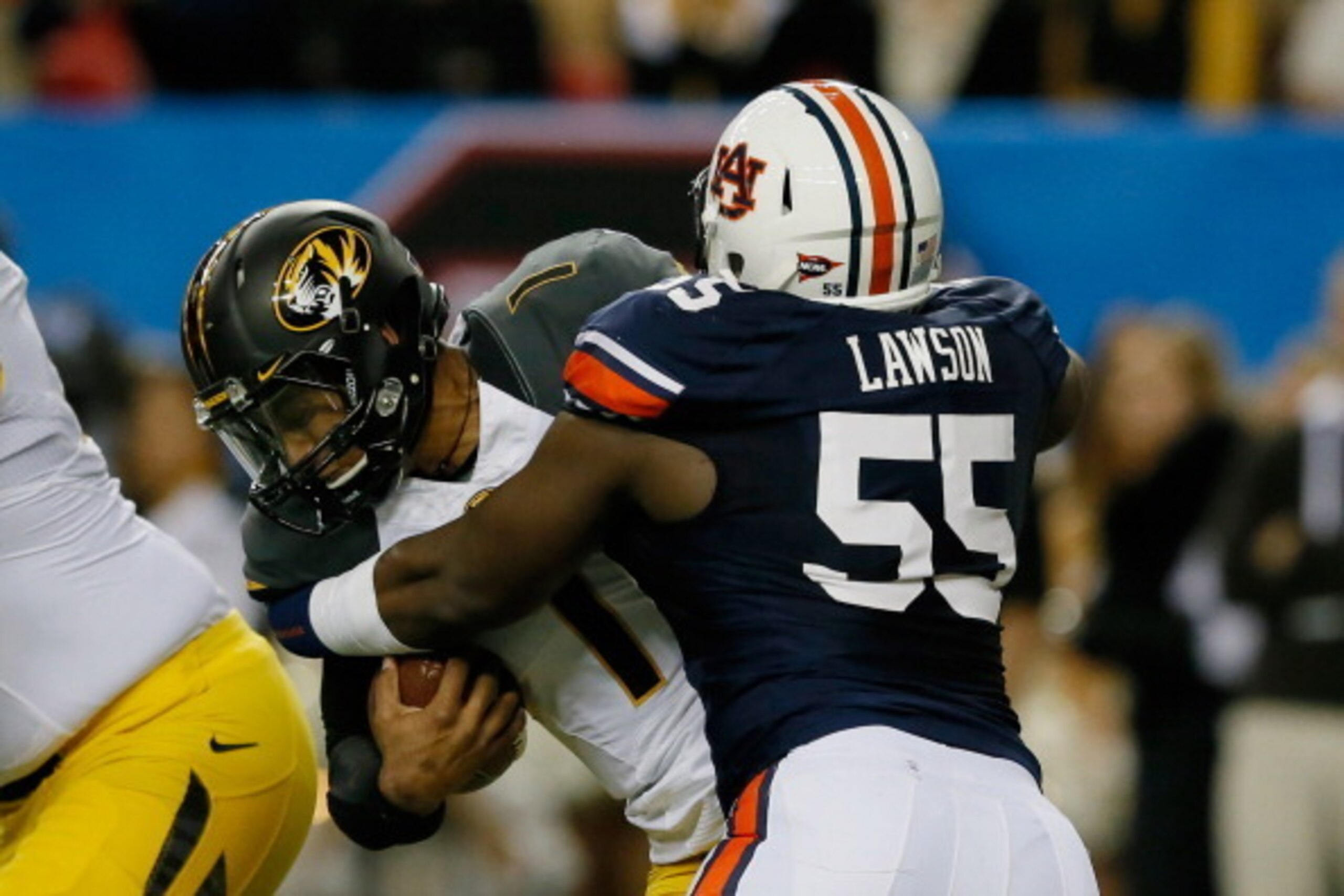 ATLANTA, GA - DECEMBER 07:  Carl Lawson #55 of the Auburn Tigers tackles quarterback James Franklin #1 of the Missouri Tigers in the second quarter during the SEC Championship Game at Georgia Dome on December 7, 2013 in Atlanta, Georgia.  (Photo by Kevin 