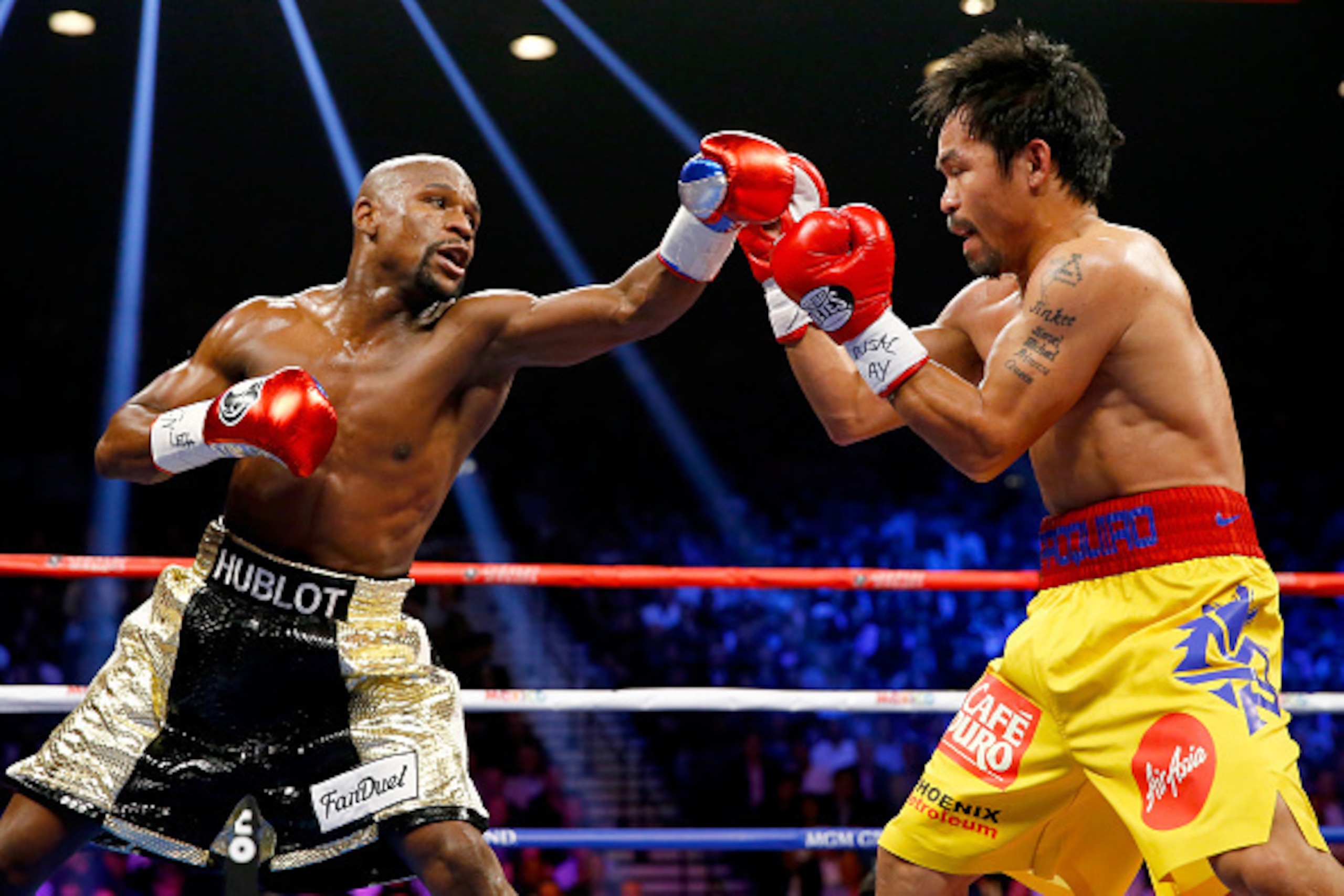 LAS VEGAS, NV - MAY 02: Floyd Mayweather Jr. throws a left at Manny Pacquiao during their welterweight unification championship bout on May 2, 2015 at MGM Grand Garden Arena in Las Vegas, Nevada. (Photo by Al Bello/Getty Images) LAS VEGAS, NV - MAY 02: Floyd Mayweather Jr. throws a left at Manny Pacquiao during their welterweight unification championship bout on May 2, 2015 at MGM Grand Garden Arena in Las Vegas, Nevada. (Photo by Al Bello/Getty Images)