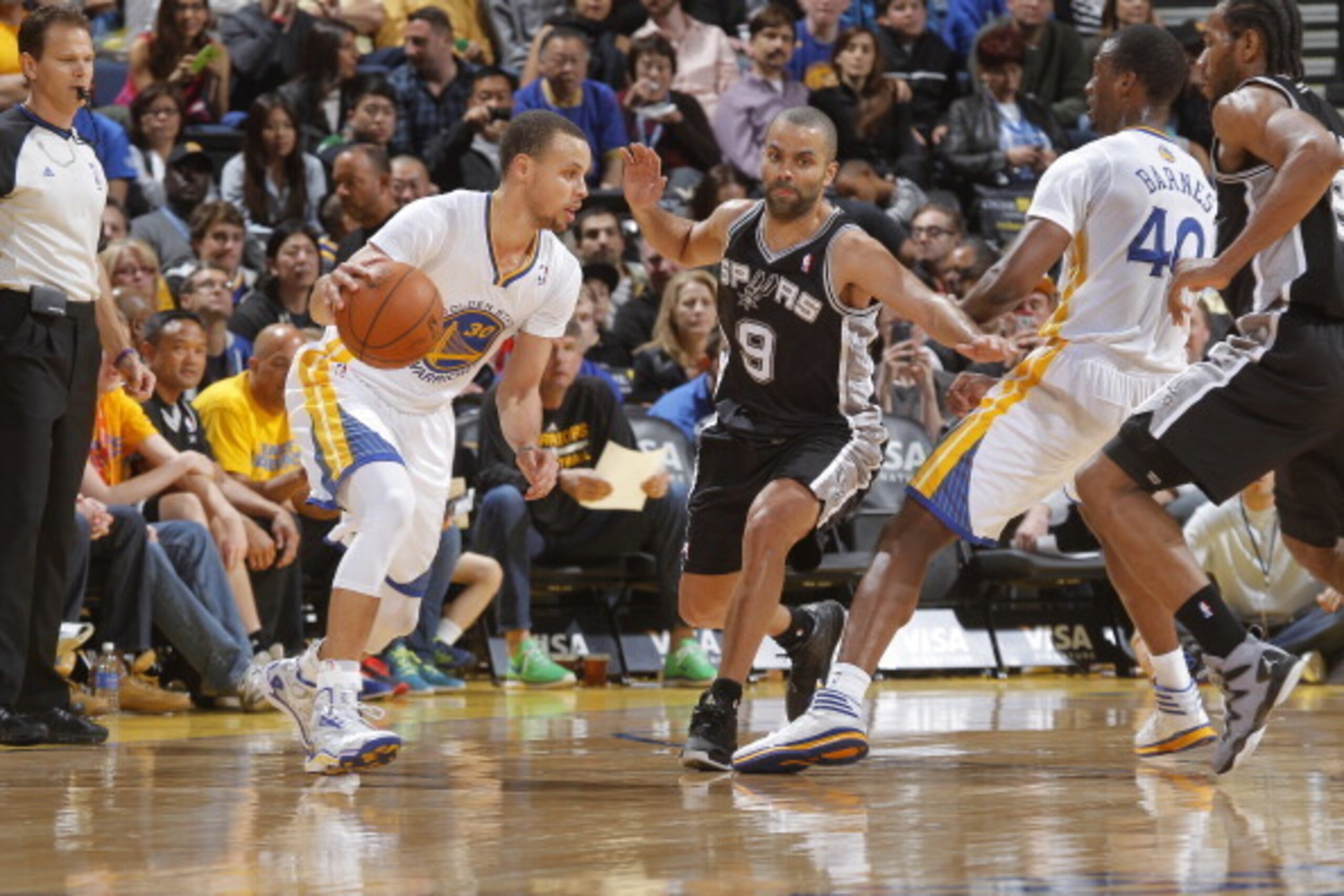 OAKLAND, CA - MARCH 22: Stephen Curry #30 of the Golden State Warriors handles the ball against Tony Parker #9 of the San Antonio Spurs on March 22, 2014 at Oracle Arena in Oakland, California. NOTE TO USER: User expressly acknowledges and agrees that, by