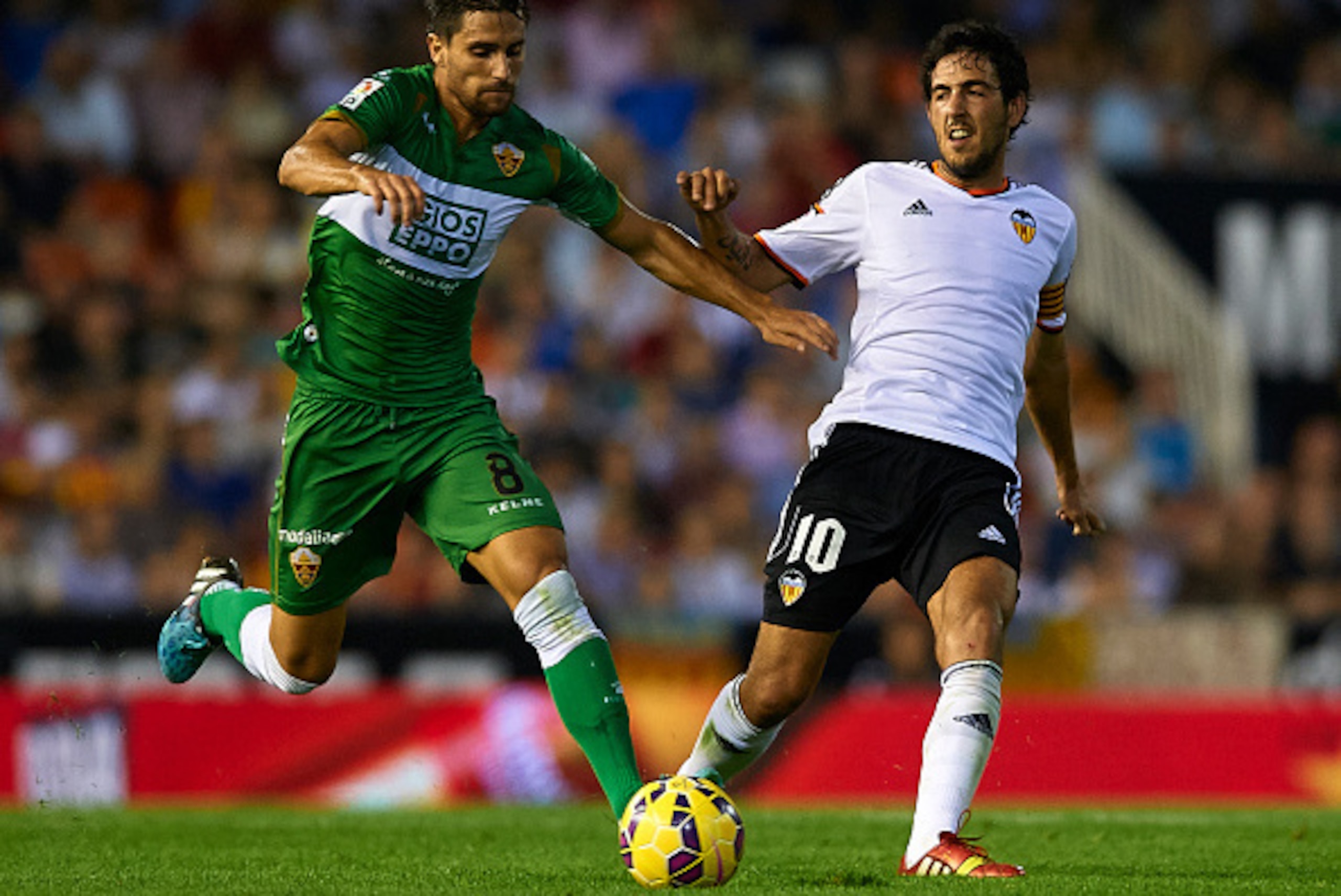 VALENCIA, SPAIN - OCTOBER 25:  Dani Parejo (R) of Valencia competes for the ball with Adrian Gonzalez of Elche during the La Liga match between Valencia CF and Elche CF at Estadio Mestalla on October 25, 2014 in Valencia, Spain.  (Photo by Manuel Queimade