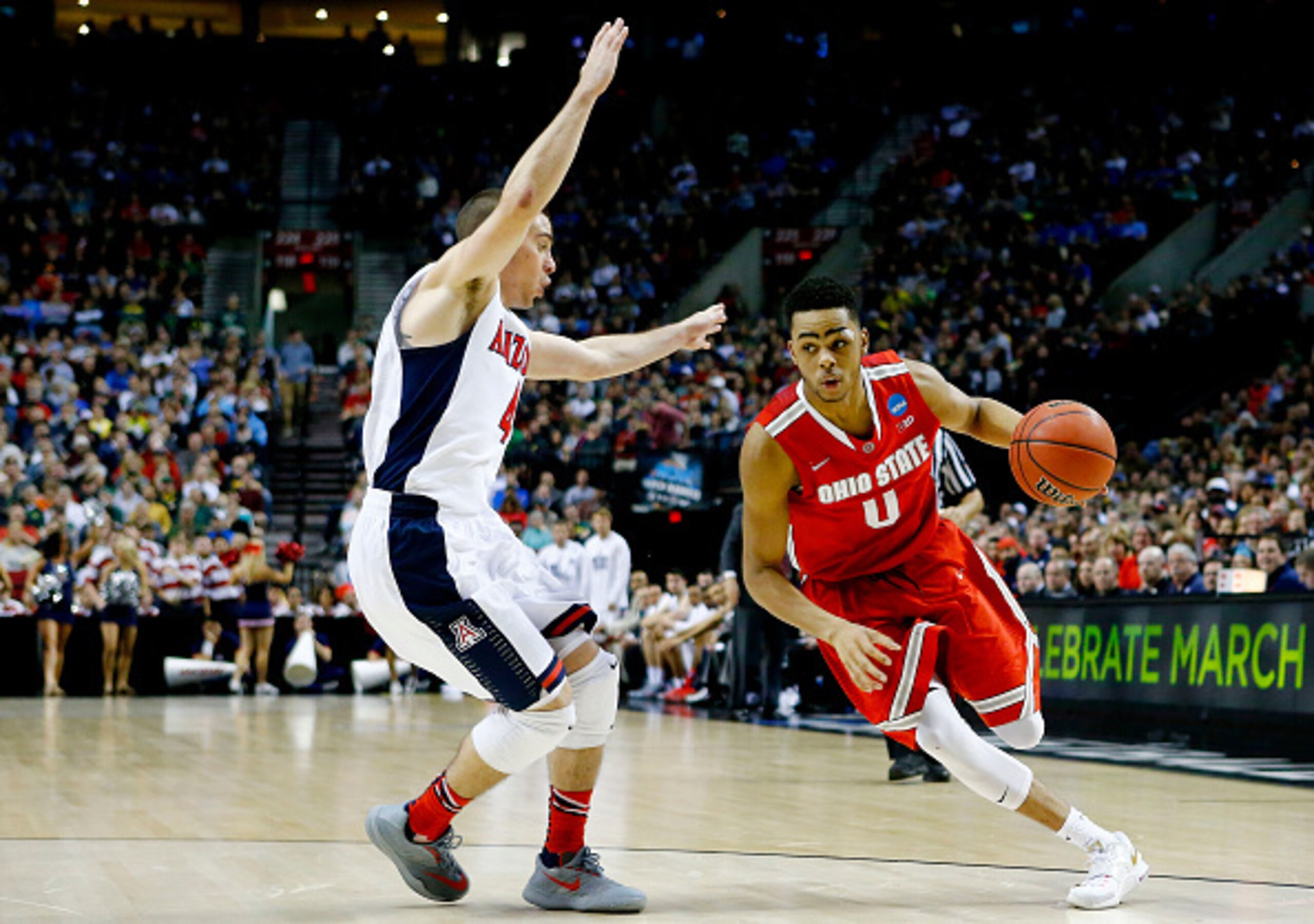 PORTLAND, OR - MARCH 21:  D'Angelo Russell #0 of the Ohio State Buckeyes drives against T.J. McConnell #4 of the Arizona Wildcats in the second half during the third round of the 2015 NCAA Men's Basketball Tournament at Moda Center on March 21, 2015 in Po