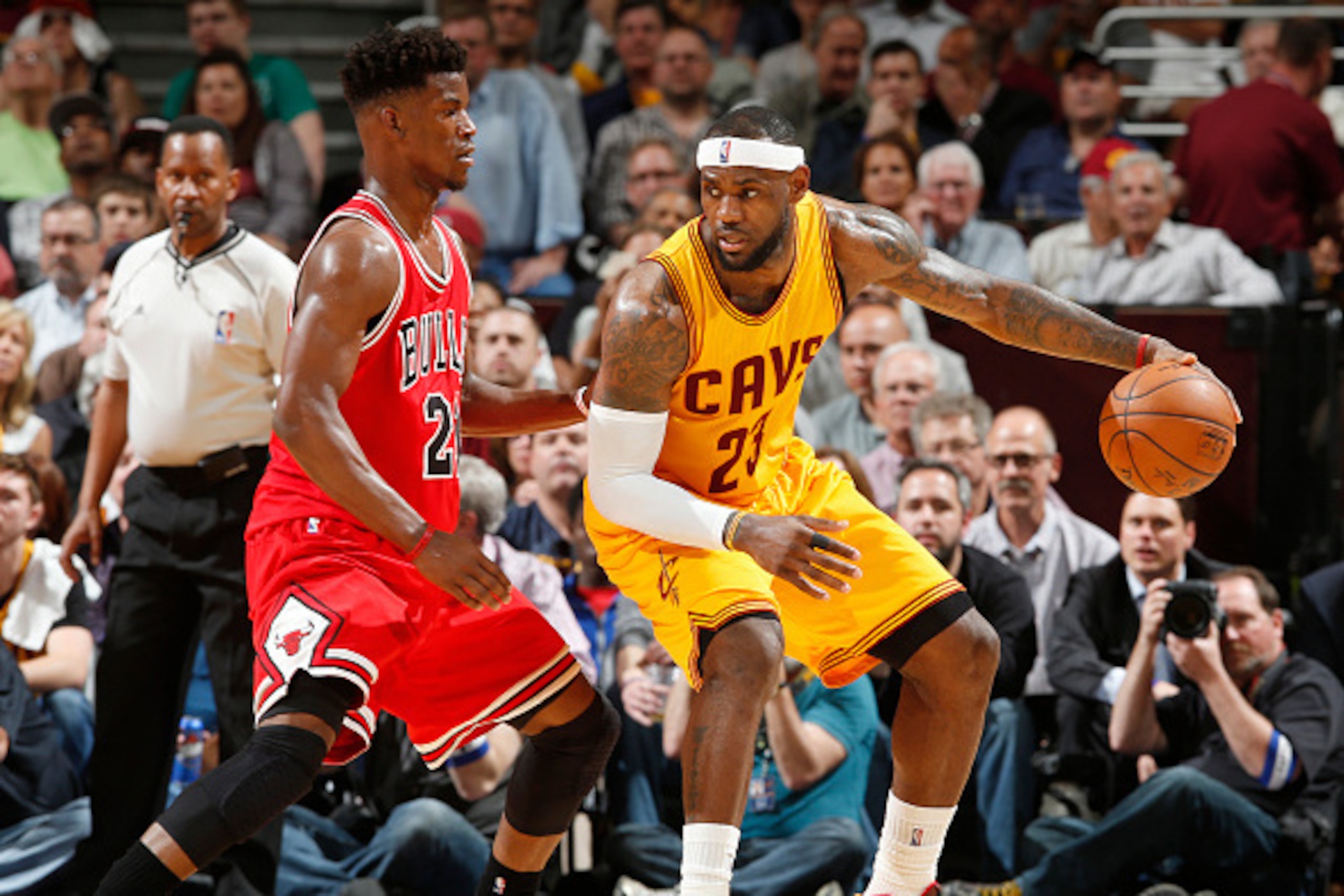 CLEVELAND, OHIO - MAY 6: LeBron James #23 of the Cleveland Cavaliers drives to the basket against Jimmy Butler #21 of the Chicago Bulls during Game Two of the Eastern Conference Semifinals during the NBA Playoffs on May 6, 2015 at Quicken Loans Arena in C