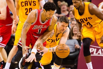 CLEVELAND, OH - MAY 6:  Derrick Rose #1 of the Chicago Bulls steals a rebound from Mike Miller #18 of the Cleveland Cavaliers in the first half during Game Two in the Eastern Conference Semifinals of the 2015 NBA Playoffs 2015 at Quicken Loans Arena on Ma