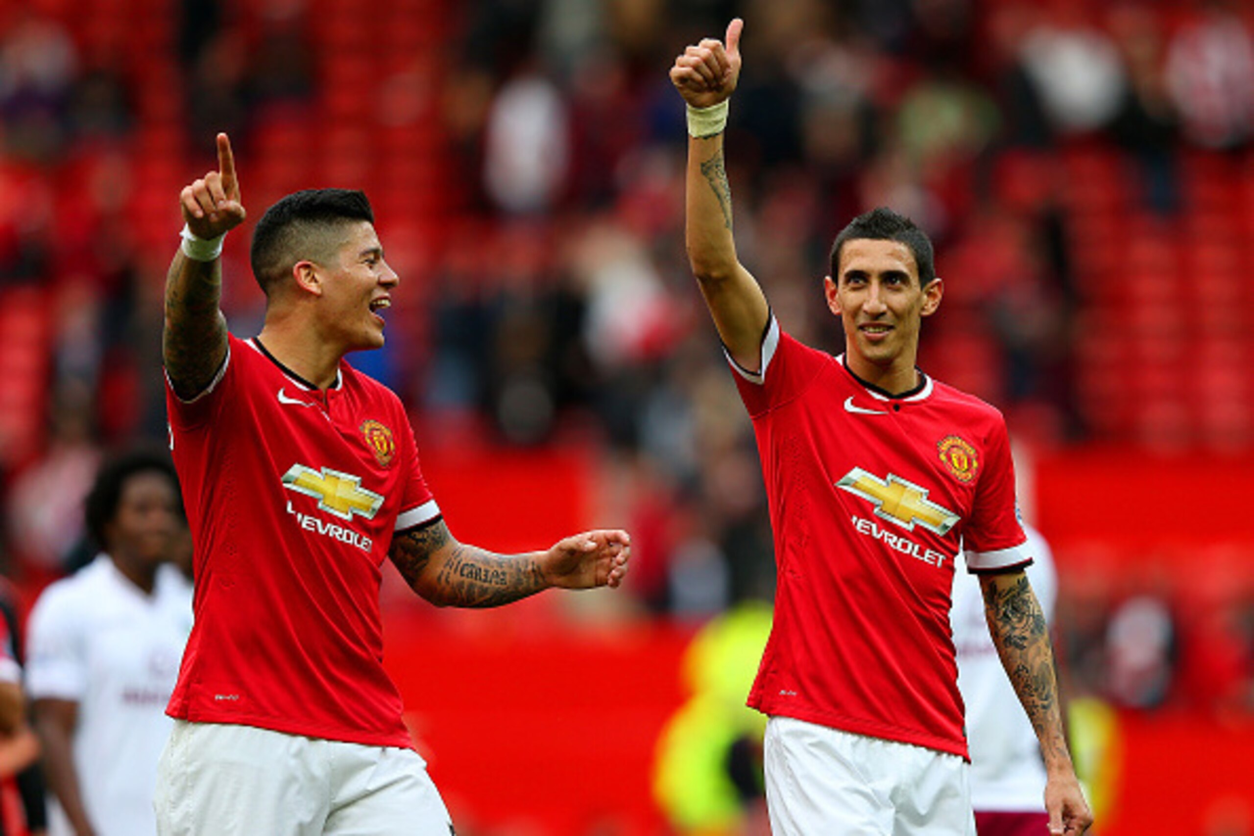 MANCHESTER, ENGLAND - APRIL 04:  Angel di Maria of Manchester United gives a thumbs up to the crowd next to team-mate Marcos Rojo after the Barclays Premier League match between Manchester United and Aston Villa at Old Trafford on April 4, 2015 in Manches