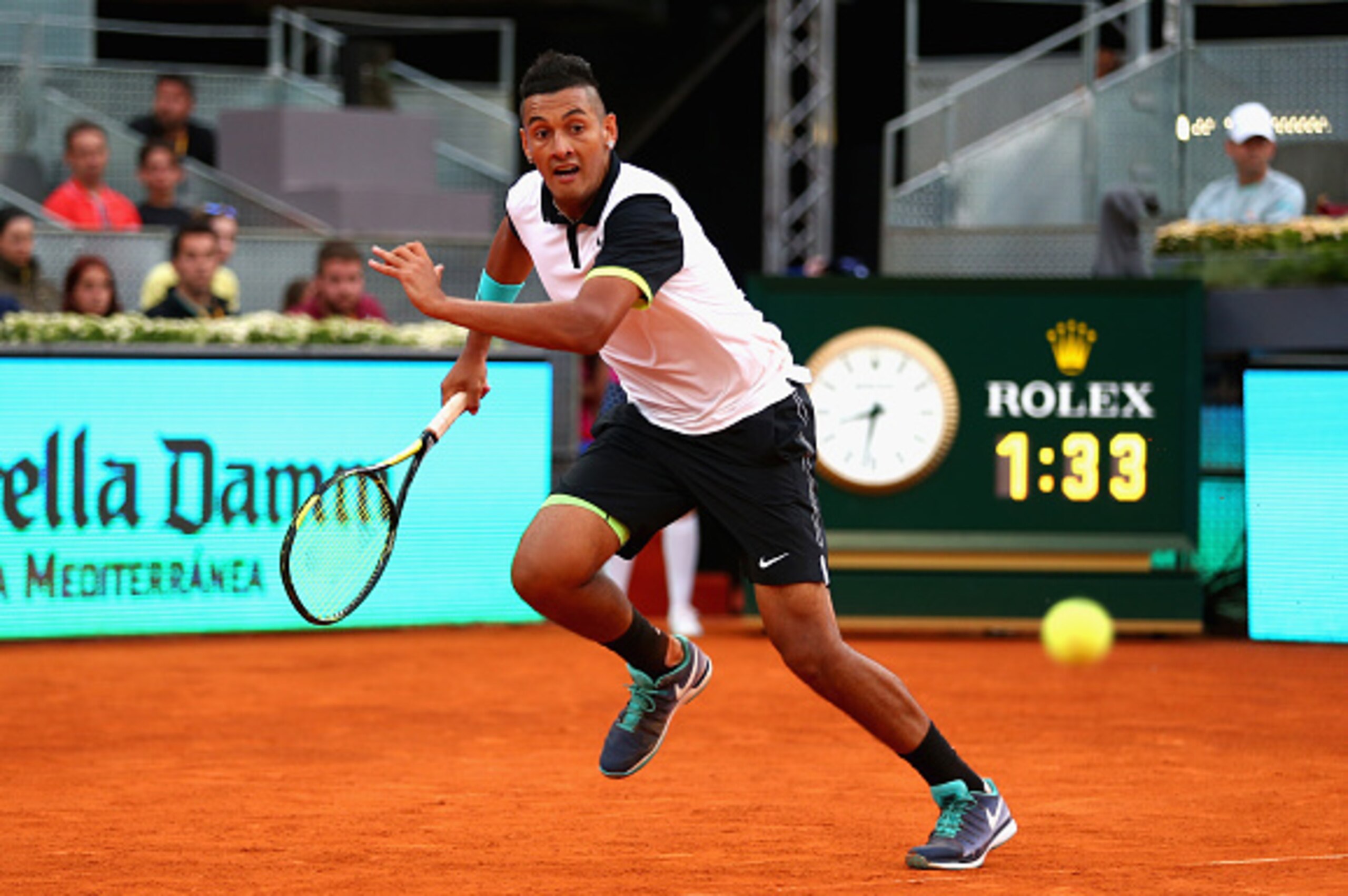 MADRID, SPAIN - MAY 06:  Nick Kyrgios of Australia in action against Roger Federer of Switzerland in their second round match during day five of the Mutua Madrid Open tennis tournament at the Caja Magica  on May 6, 2015 in Madrid, Spain.  (Photo by Clive 