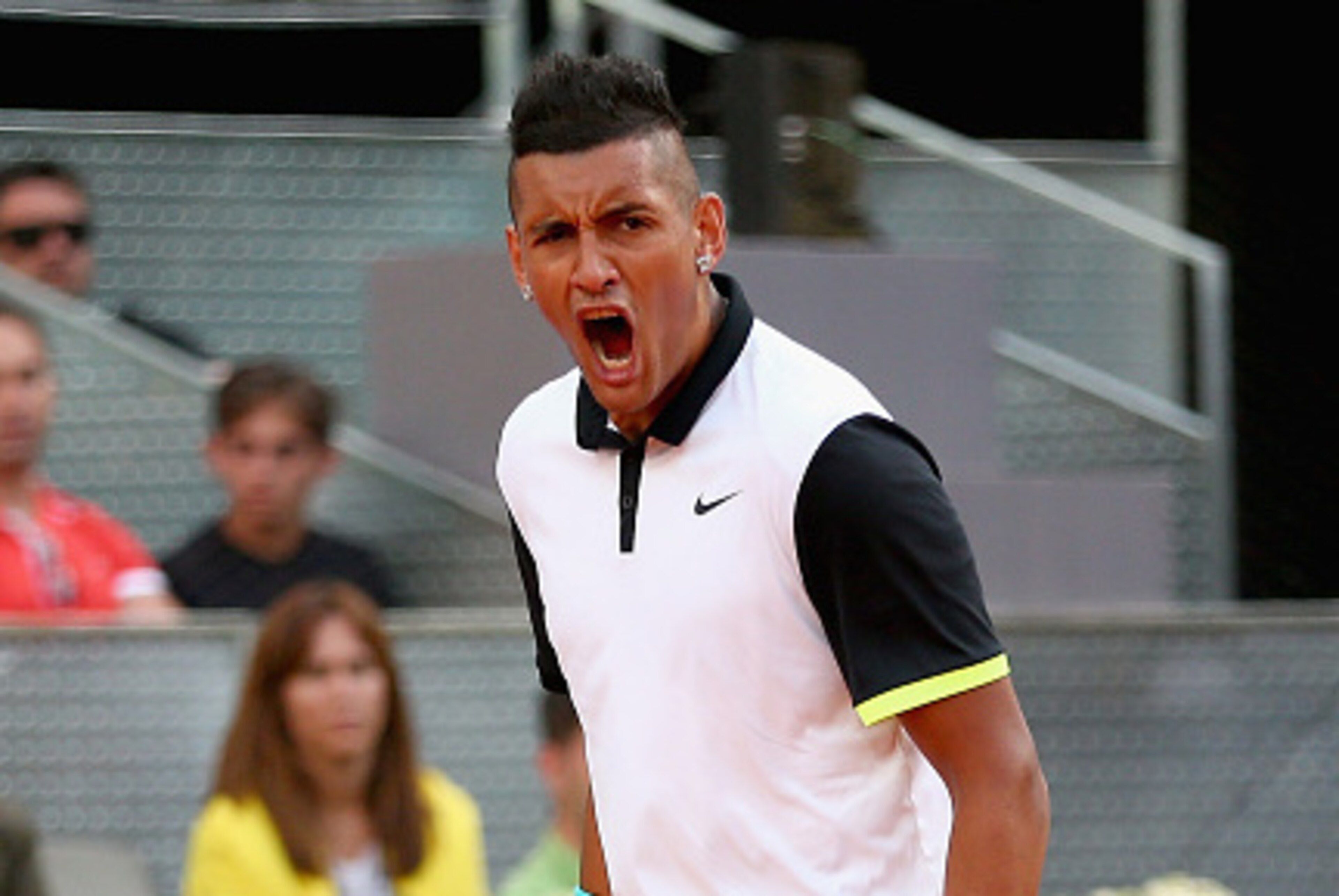MADRID, SPAIN - MAY 06: Nick Kyrgios of Australia celebrates winning a game against Roger Federer of Switzerland in their second round match during day five of the Mutua Madrid Open tennis tournament at the Caja Magica on May 6, 2015 in Madrid, Spain. MADRID, SPAIN - MAY 06: Nick Kyrgios of Australia celebrates winning a game against Roger Federer of Switzerland in their second round match during day five of the Mutua Madrid Open tennis tournament at the Caja Magica on May 6, 2015 in Madrid, Spain.