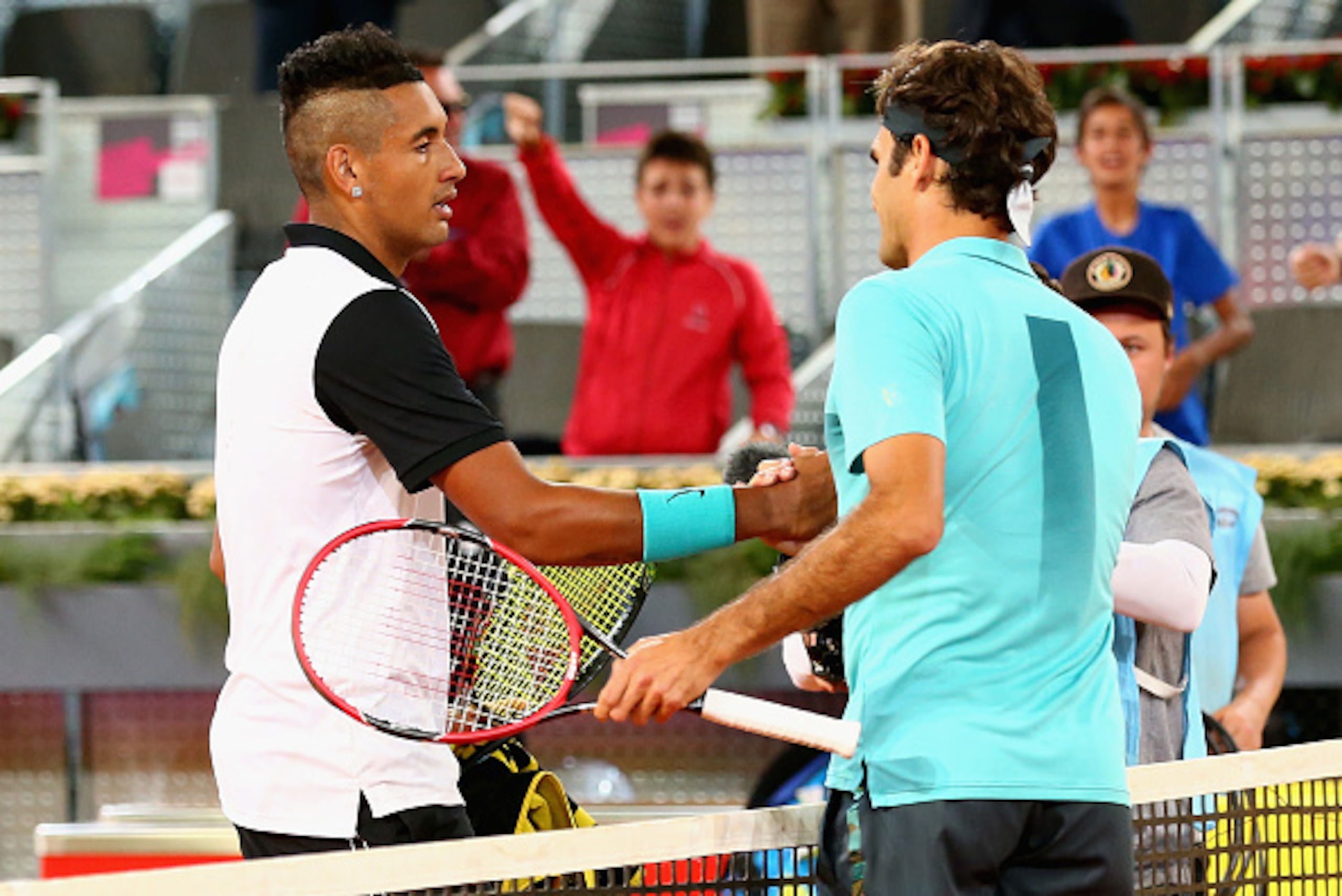 MADRID, SPAIN - MAY 06:  Nick Kyrgios of Australia shakes hands at the net after his three set victory against Roger Federer of Switzerland in their second round match during day five of the Mutua Madrid Open tennis tournament at the Caja Magica  on May 6