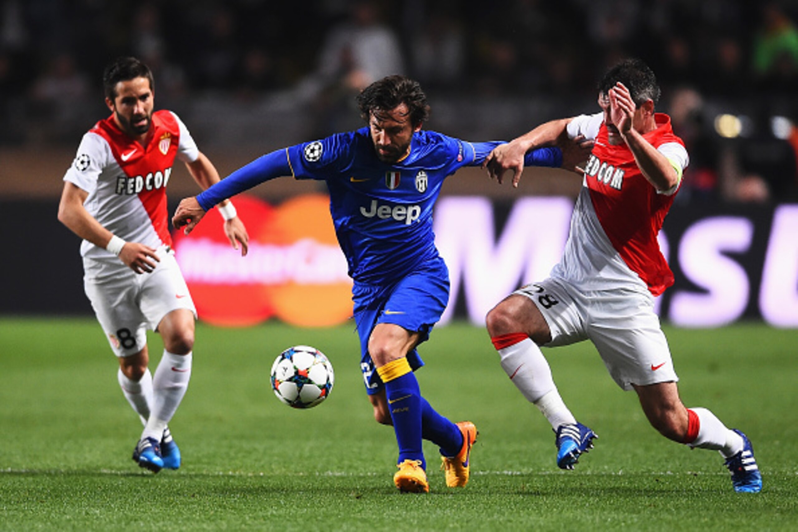 MONACO - APRIL 22: Andrea Pirlo of Juventus is challenged by Jeremy Toulalan of Monaco watched by Joao Moutinho (L) of Monaco during the UEFA Champions League quarter-final second leg match between AS Monaco FC and Juventus at Stade Louis II on April 22, MONACO - APRIL 22: Andrea Pirlo of Juventus is challenged by Jeremy Toulalan of Monaco watched by Joao Moutinho (L) of Monaco during the UEFA Champions League quarter-final second leg match between AS Monaco FC and Juventus at Stade Louis II on April 22,