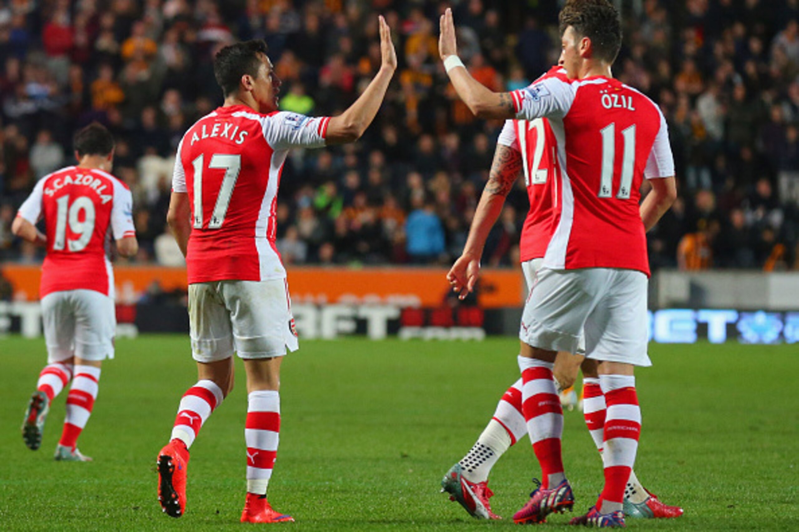 HULL, ENGLAND - MAY 04:  Alexis Sanchez of Arsenal celebrates with Mesut Oezil as he scores their third goal during the Barclays Premier League match between Hull City and Arsenal at KC Stadium on May 4, 2015 in Hull, England.  (Photo by Alex Livesey/Gett