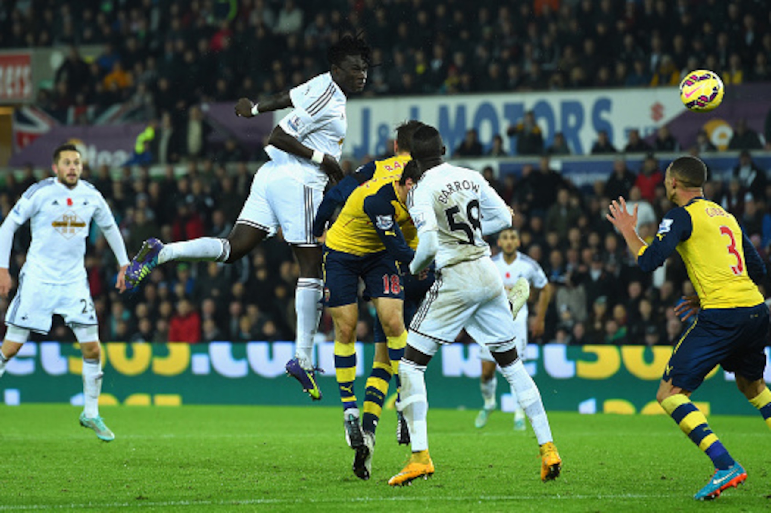 SWANSEA, WALES - NOVEMBER 09:  Swansea player Bafetimbi Gomis (c) heads the second Swansea goal during the Barclays Premier League match between Swansea City and Arsenal at Liberty Stadium on November 9, 2014 in Swansea, Wales.  (Photo by Stu Forster/Gett