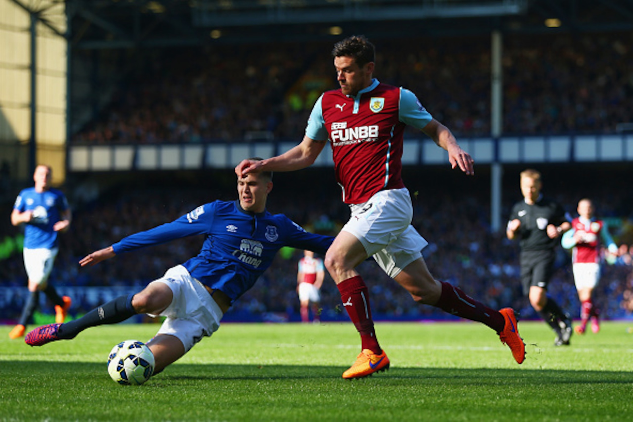 LIVERPOOL, ENGLAND - APRIL 18:  John Stones of Everton slides in to challenge Lukas Jutkiewicz of Burnley during the Barclays Premier League match between Everton and Burnley at Goodison Park on April 18, 2015 in Liverpool, England.  (Photo by Clive Bruns