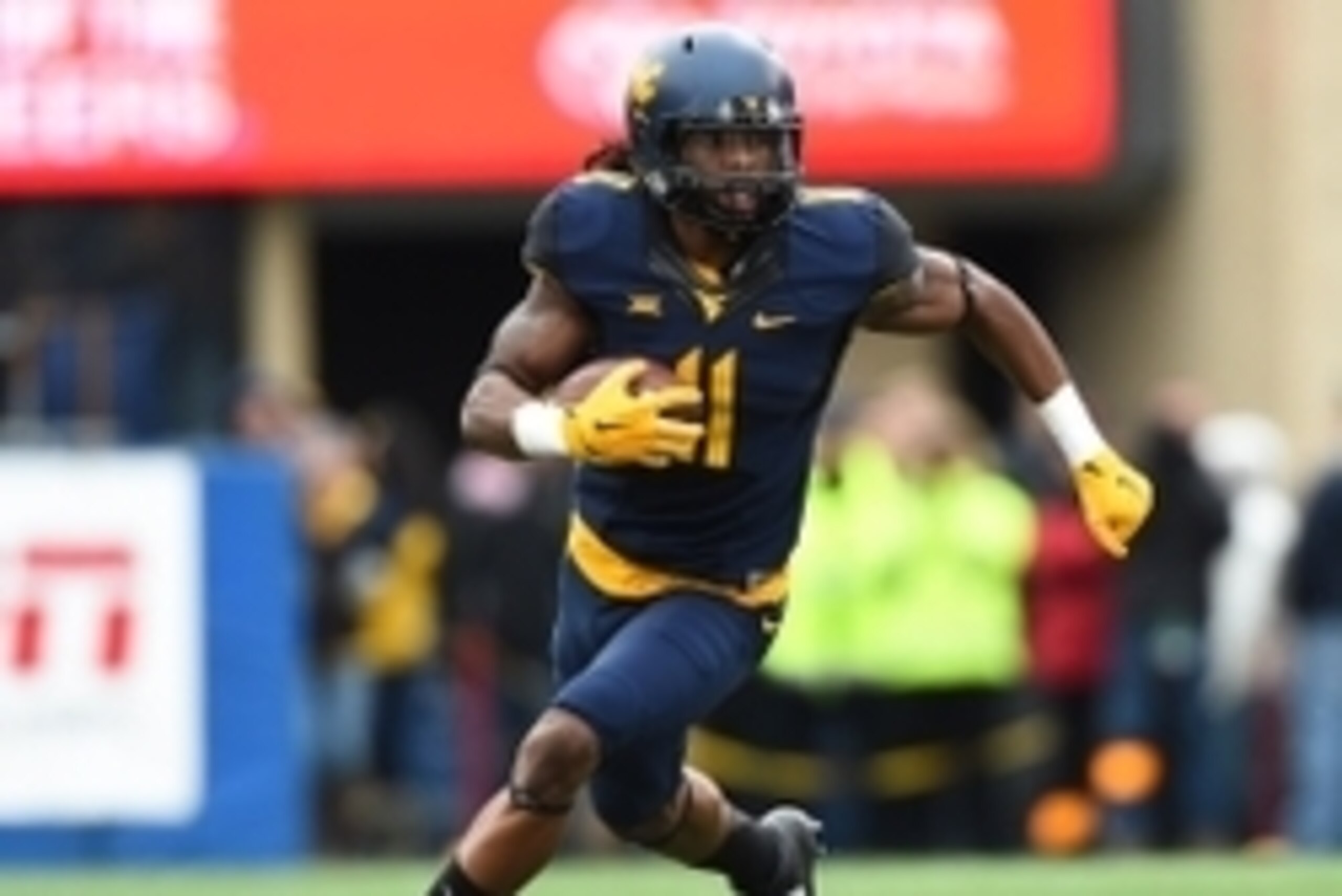 Nov 1, 2014; Morgantown, WV, USA; West Virginia Mountaineers wide receiver Kevin White (11) runs with ball after a catch during the first quarter against the TCU Horned Frogs at Milan Puskar Stadium. TCU Horned Frogs defeated West Virginia Mountaineers 31