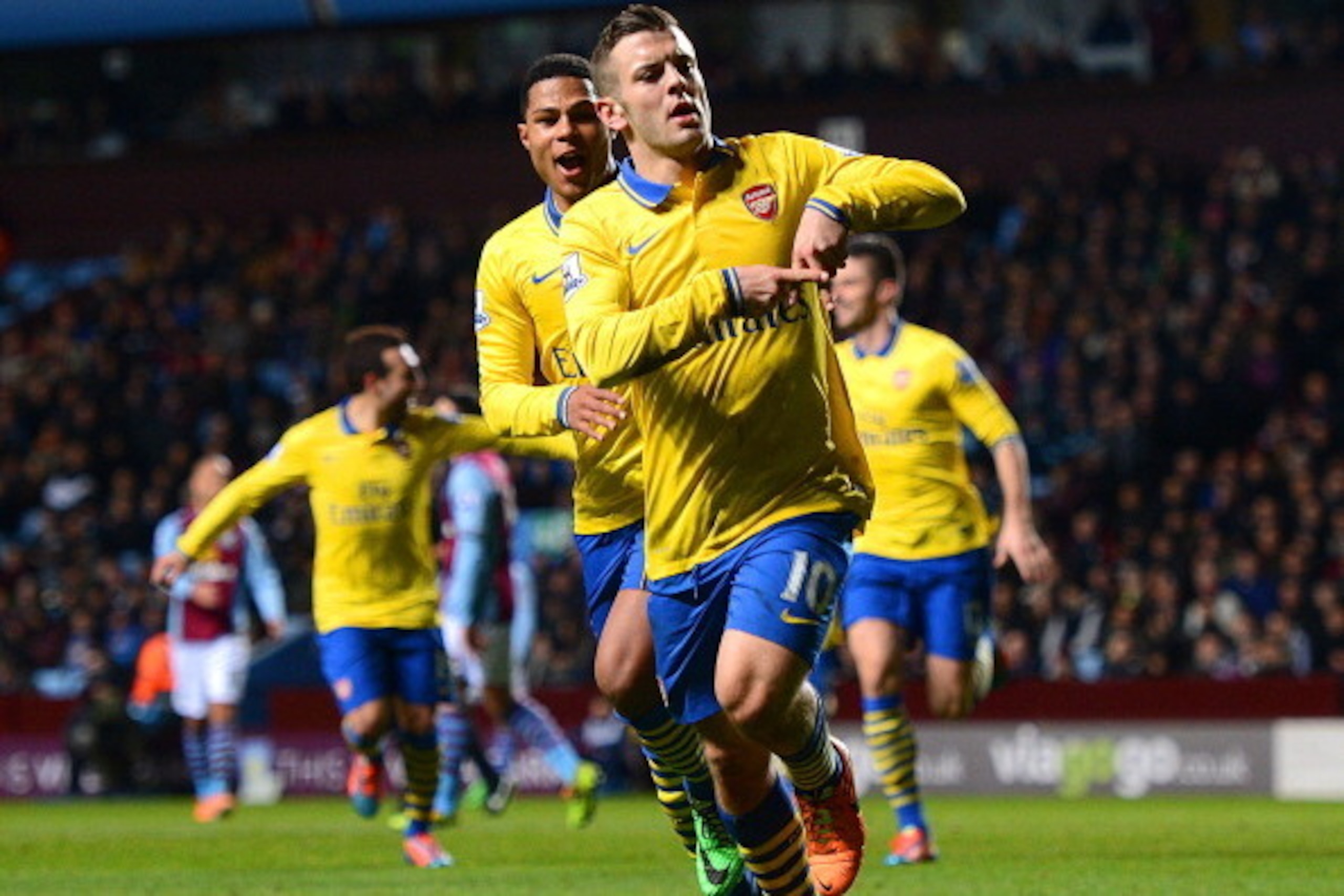 BIRMINGHAM, ENGLAND - JANUARY 13: Jack Wilshere of Arsenal ceelbrates scoring the opening goal with Serge Gnabry of Arsenal during the Barclays Premier League match between Aston Villa and Arsenal at Villa Park on January 13, 2014 in Birmingham, England. BIRMINGHAM, ENGLAND - JANUARY 13: Jack Wilshere of Arsenal ceelbrates scoring the opening goal with Serge Gnabry of Arsenal during the Barclays Premier League match between Aston Villa and Arsenal at Villa Park on January 13, 2014 in Birmingham, England.