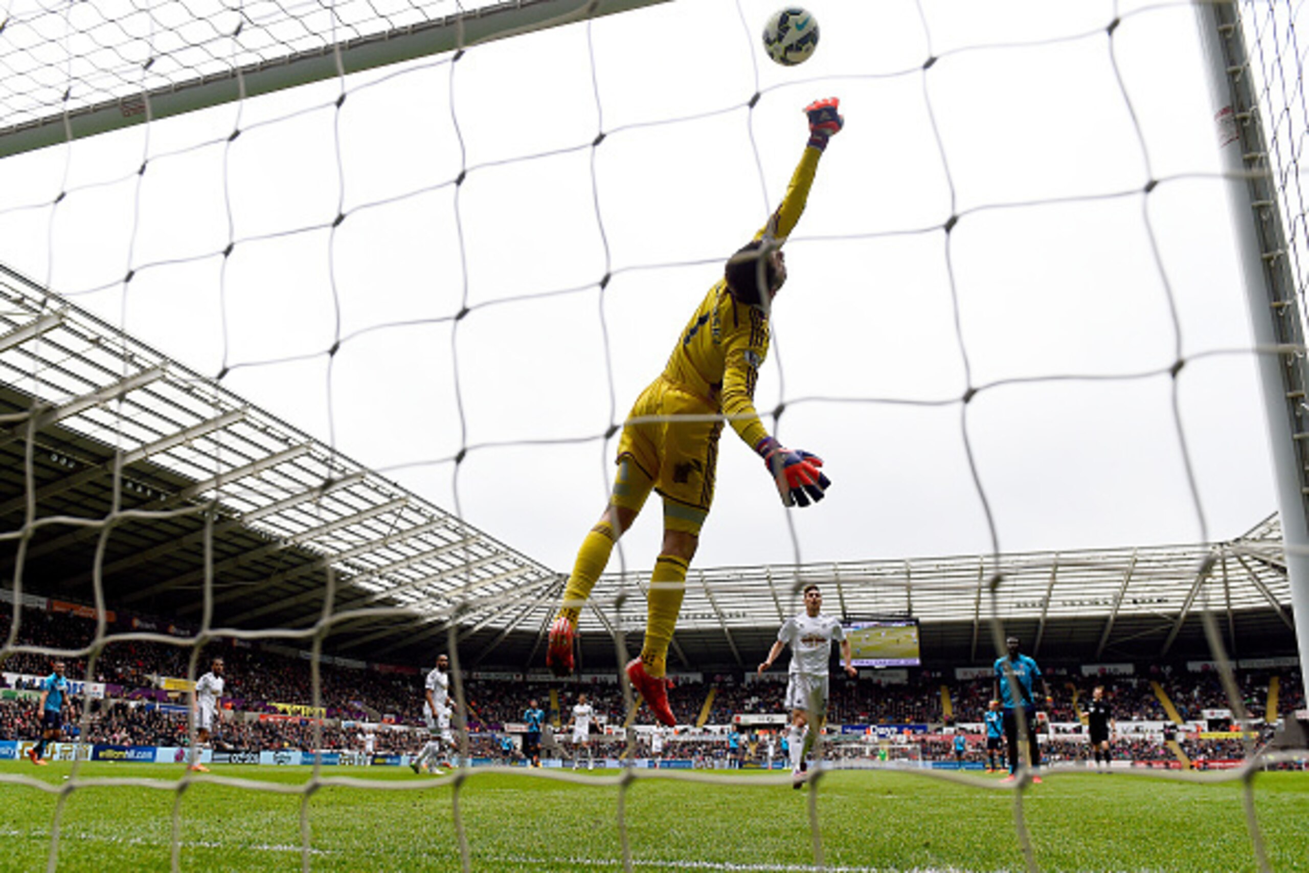 SWANSEA, WALES - MAY 02: Lukasz Fabianski of Swansea City makes a save during the Barclays Premier League match between Swansea City and Stoke City at Liberty Stadium on May 2, 2015 in Swansea, Wales. (Photo by Mike Hewitt/Getty Images) SWANSEA, WALES - MAY 02: Lukasz Fabianski of Swansea City makes a save during the Barclays Premier League match between Swansea City and Stoke City at Liberty Stadium on May 2, 2015 in Swansea, Wales. (Photo by Mike Hewitt/Getty Images)