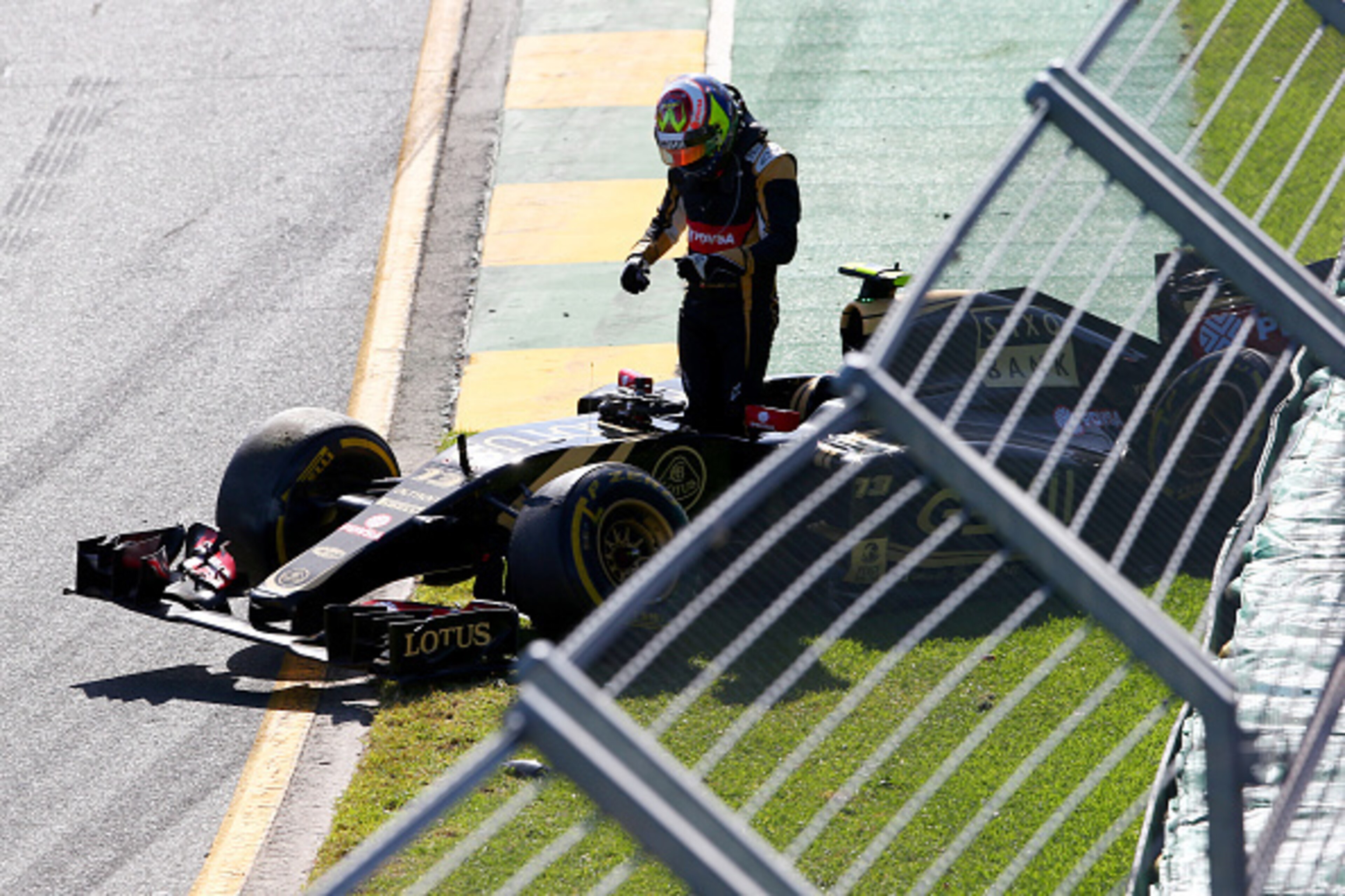 MELBOURNE, AUSTRALIA - MARCH 15:  Pastor Maldonado of Venezuela and Lotus crashes at the second corner during the Australian Formula One Grand Prix at Albert Park on March 15, 2015 in Melbourne, Australia.  (Photo by Mark Thompson/Getty Images)