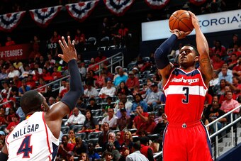 ATLANTA, GA - MAY 05:  Bradley Beal #3 of the Washington Wizards attempts a three-point basket against Paul Millsap #4 of the Atlanta Hawks during Game Two of the Eastern Conference Semifinals of the 2015 NBA Playoffs at Philips Arena on May 5, 2015 in At