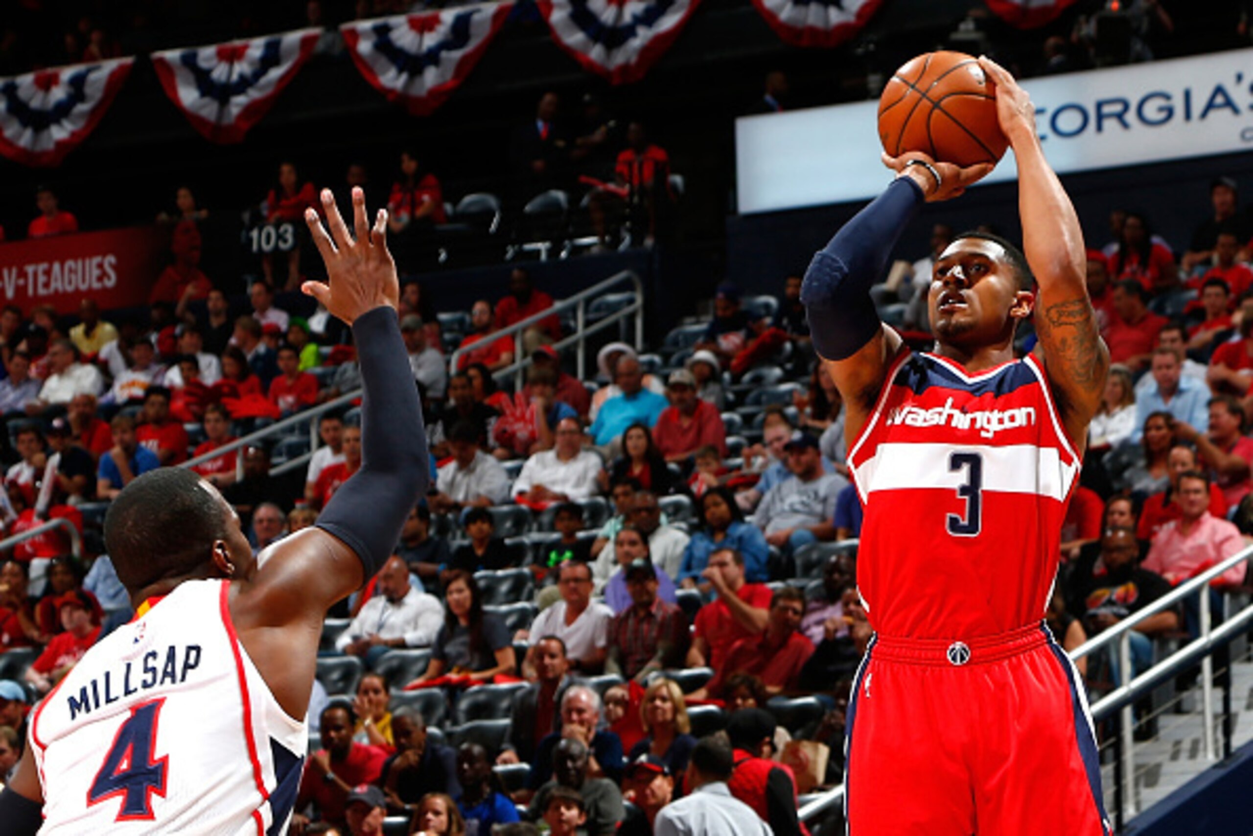 ATLANTA, GA - MAY 05:  Bradley Beal #3 of the Washington Wizards attempts a three-point basket against Paul Millsap #4 of the Atlanta Hawks during Game Two of the Eastern Conference Semifinals of the 2015 NBA Playoffs at Philips Arena on May 5, 2015 in At