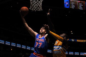 DENVER, CO - March 9:   Andrea Bargnani #77 of the New York Knicks drives to the basket against the Denver Nuggets on March 9, 2015 at the Pepsi Center in Denver, Colorado. NOTE TO USER: User expressly acknowledges and agrees that, by downloading and/or u
