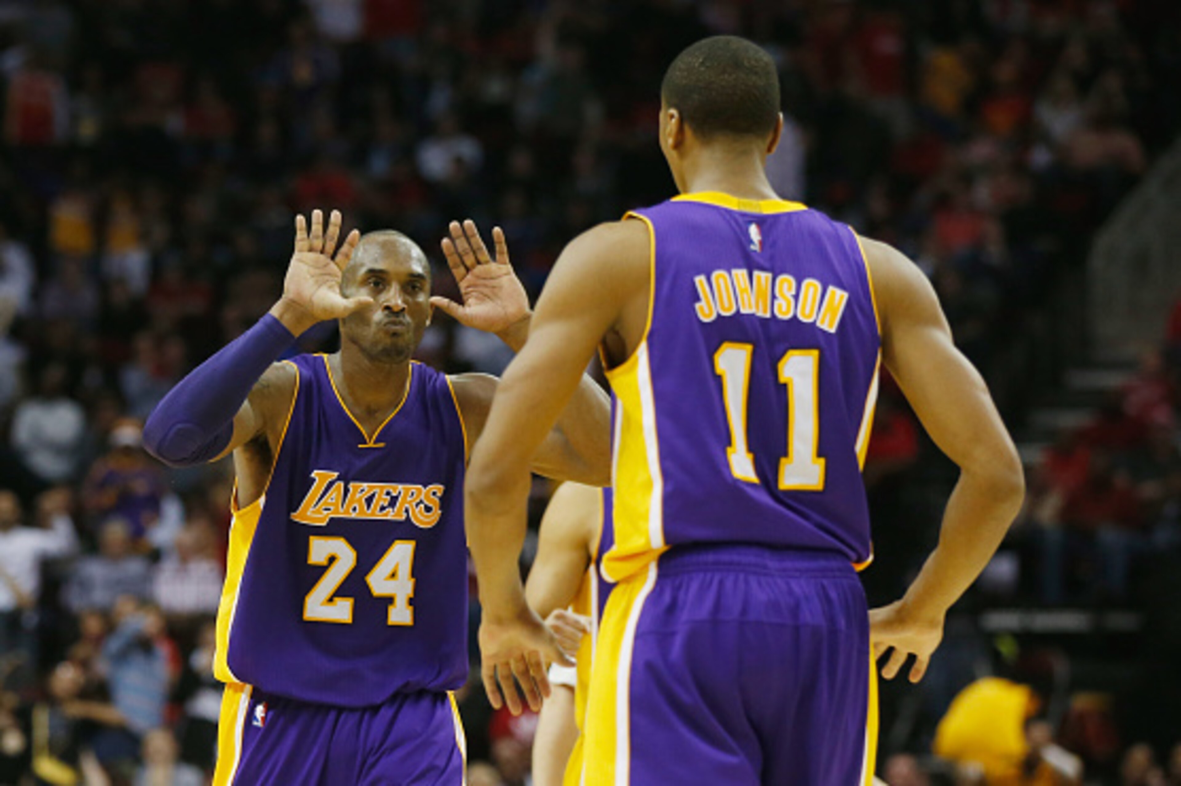 HOUSTON, TX - NOVEMBER 19:  Kobe Bryant #24 of the Los Angeles Lakers celebrates a play with Wesley Johnson #11during their game against the Houston Rockets at the Toyota Center on November 19, 2014 in Houston, Texas.  NOTE TO USER: User expressly acknowl