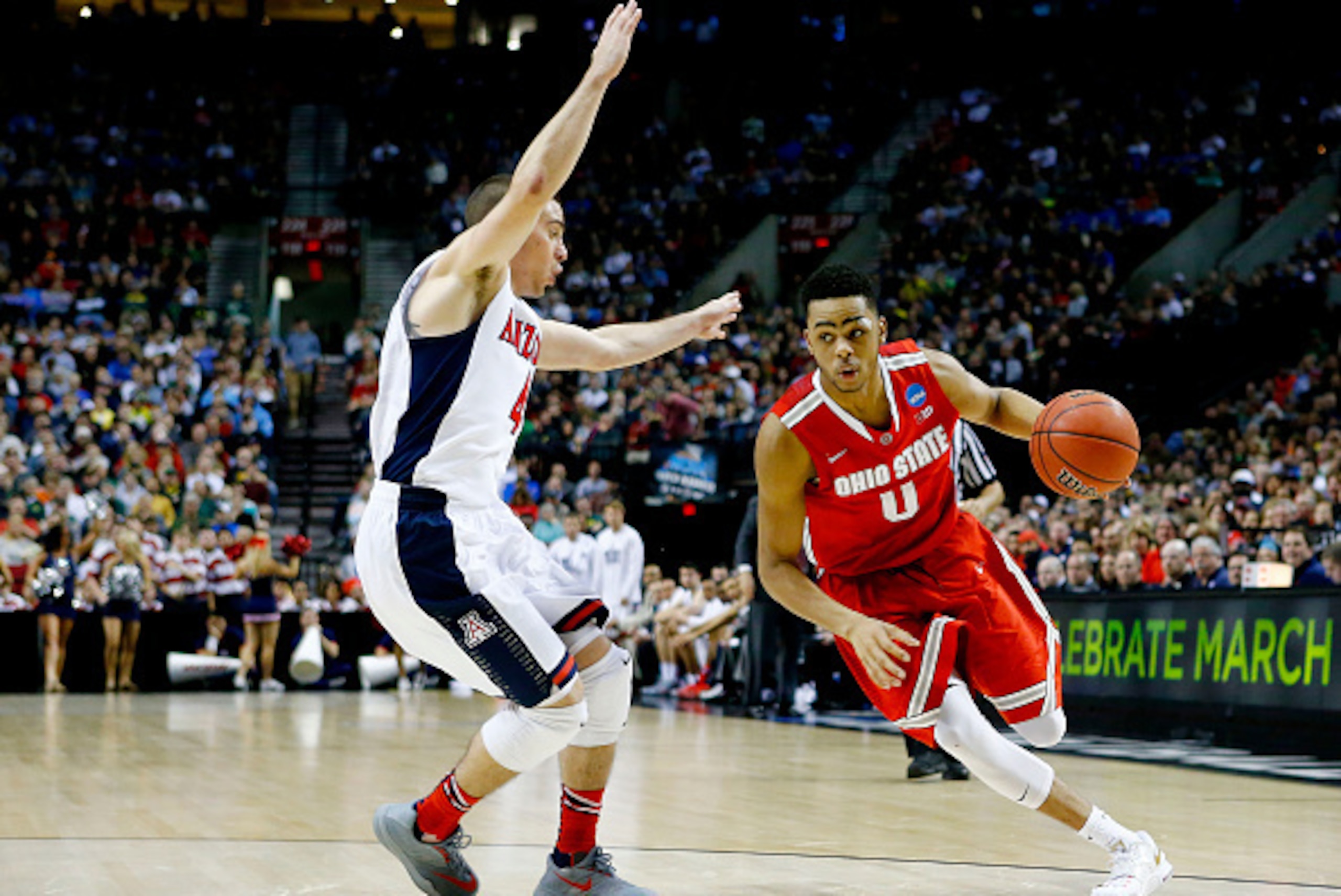PORTLAND, OR - MARCH 21:  D'Angelo Russell #0 of the Ohio State Buckeyes drives against T.J. McConnell #4 of the Arizona Wildcats in the second half during the third round of the 2015 NCAA Men's Basketball Tournament at Moda Center on March 21, 2015 in Po