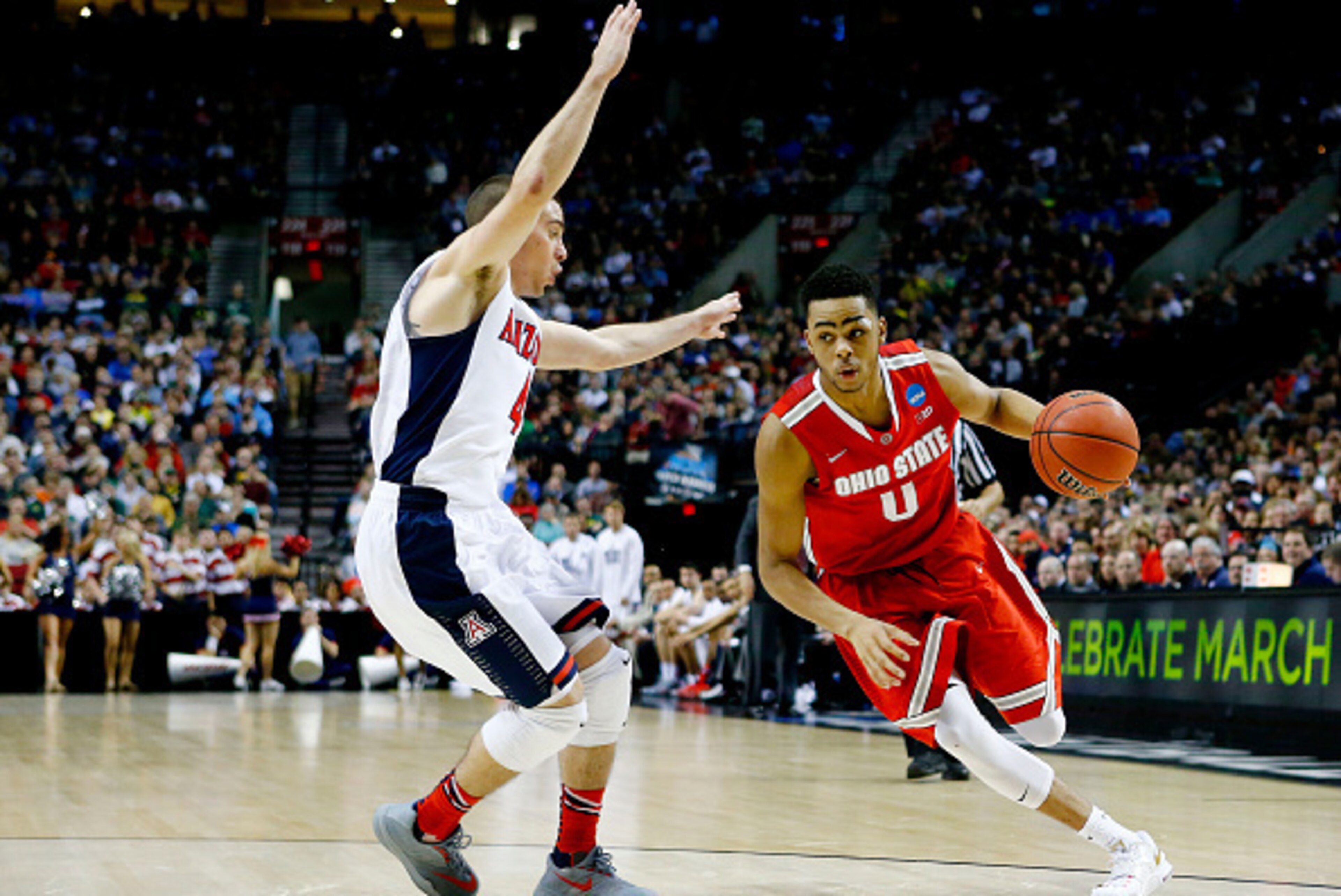 PORTLAND, OR - MARCH 21:  D'Angelo Russell #0 of the Ohio State Buckeyes drives against T.J. McConnell #4 of the Arizona Wildcats in the second half during the third round of the 2015 NCAA Men's Basketball Tournament at Moda Center on March 21, 2015 in Po