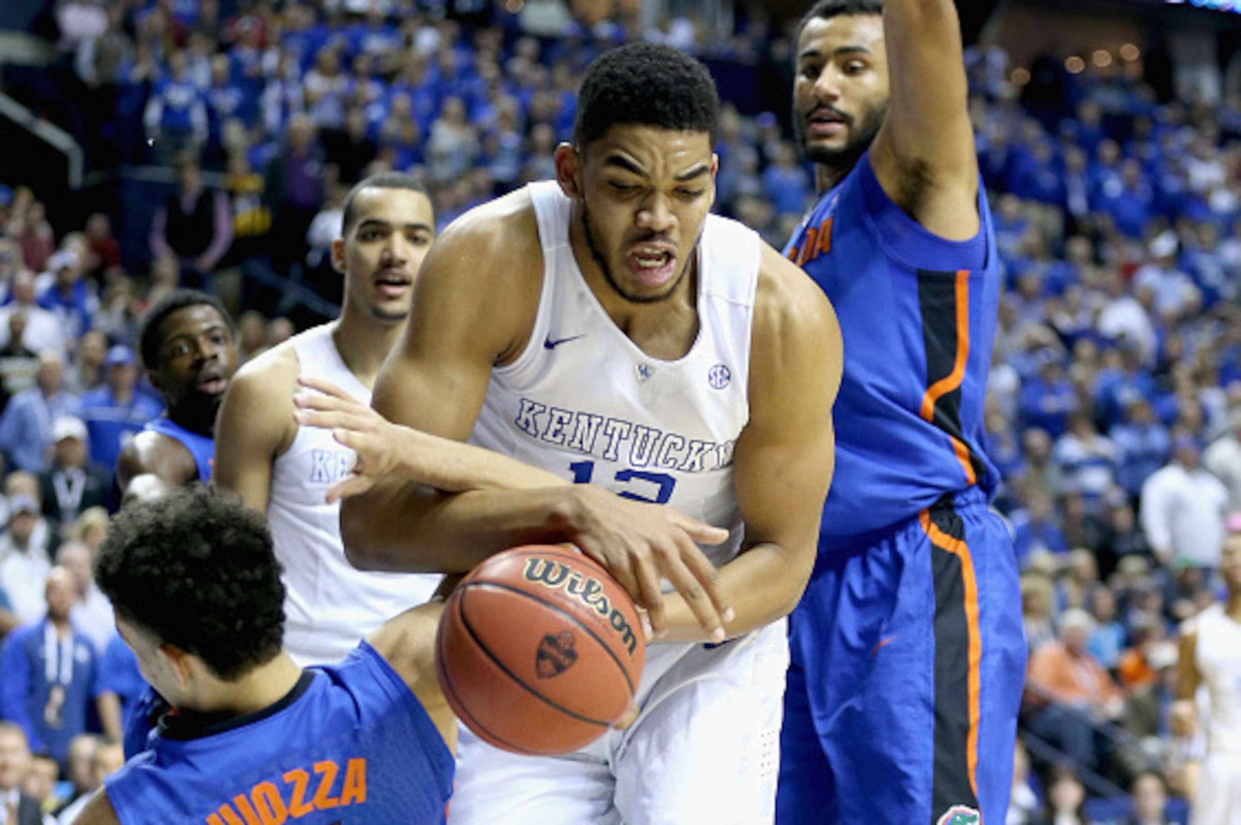NASHVILLE, TN - MARCH 13:  Karl-Anthony Towns #12 of the Kentucky Wildcats and Chris Chiozza #11 of the Florida Gators battle for a loose ball during the quaterfinals of the SEC Basketball Tournament at Bridgestone Arena on March 13, 2015 in Nashville, Te