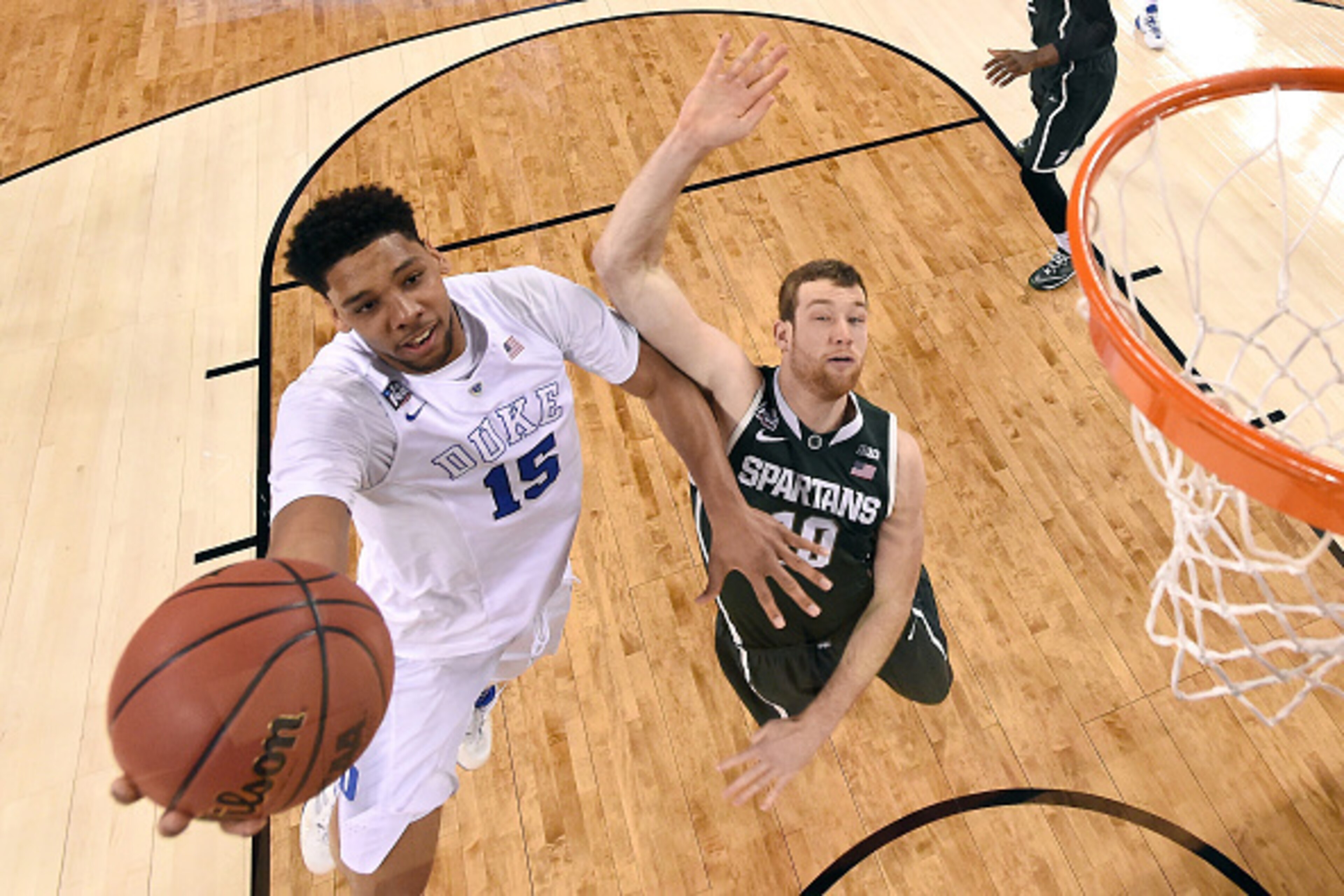 INDIANAPOLIS, IN - APRIL 04: Jahlil Okafor #15 of the Duke Blue Devils drives to the basket against Matt Costello #10 of the Michigan State Spartans in the first half during the NCAA Men's Final Four Semifinal at Lucas Oil Stadium on April 4, 2015 in Indi