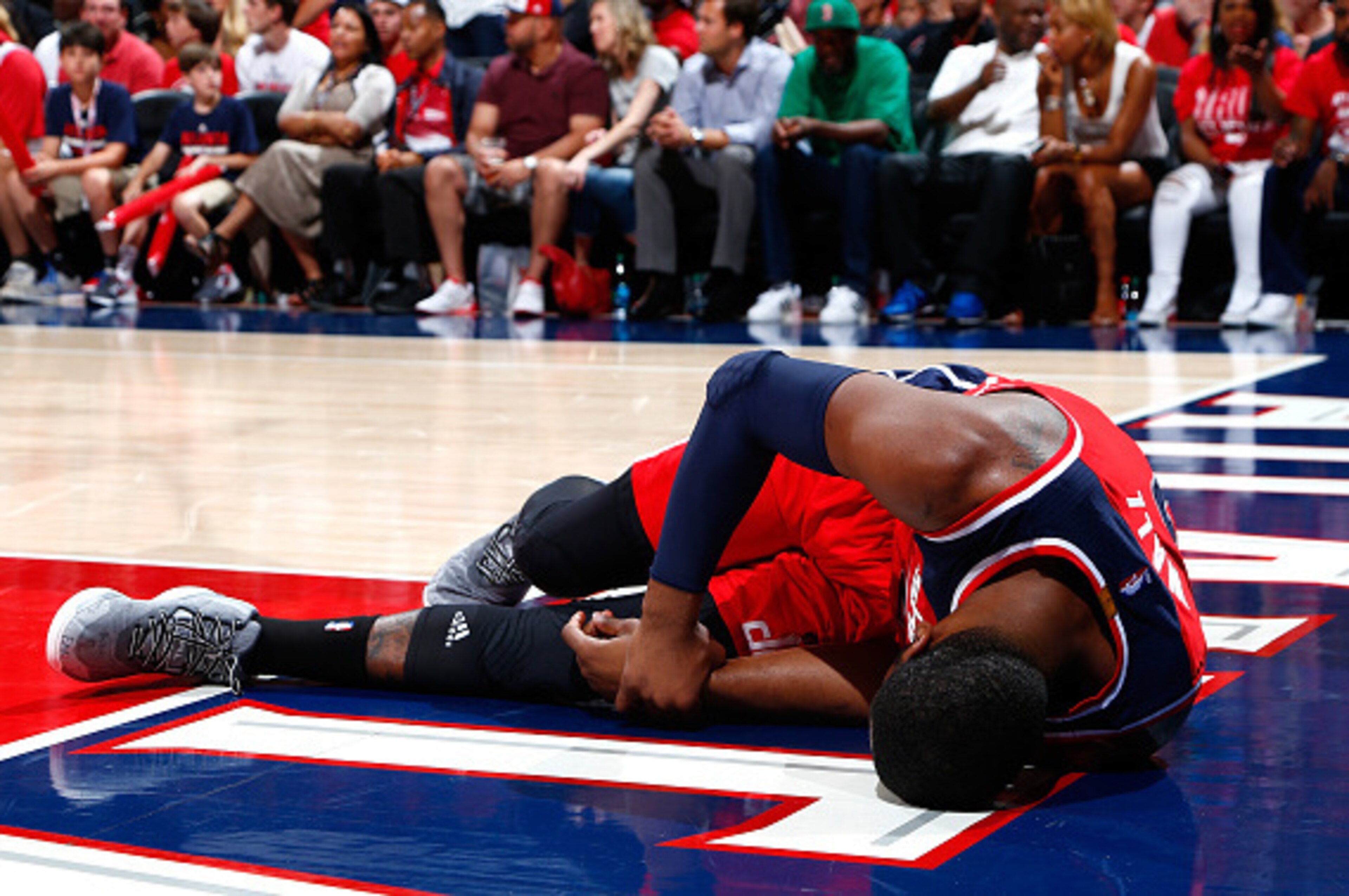 ATLANTA, GA - MAY 03:  John Wall #2 of the Washington Wizards grabs his wrist after missing a basket and landing on the floor against the Atlanta Hawks during Game One of the Eastern Conference Semifinals of the 2015 NBA Playoffs at Philips Arena on May 3