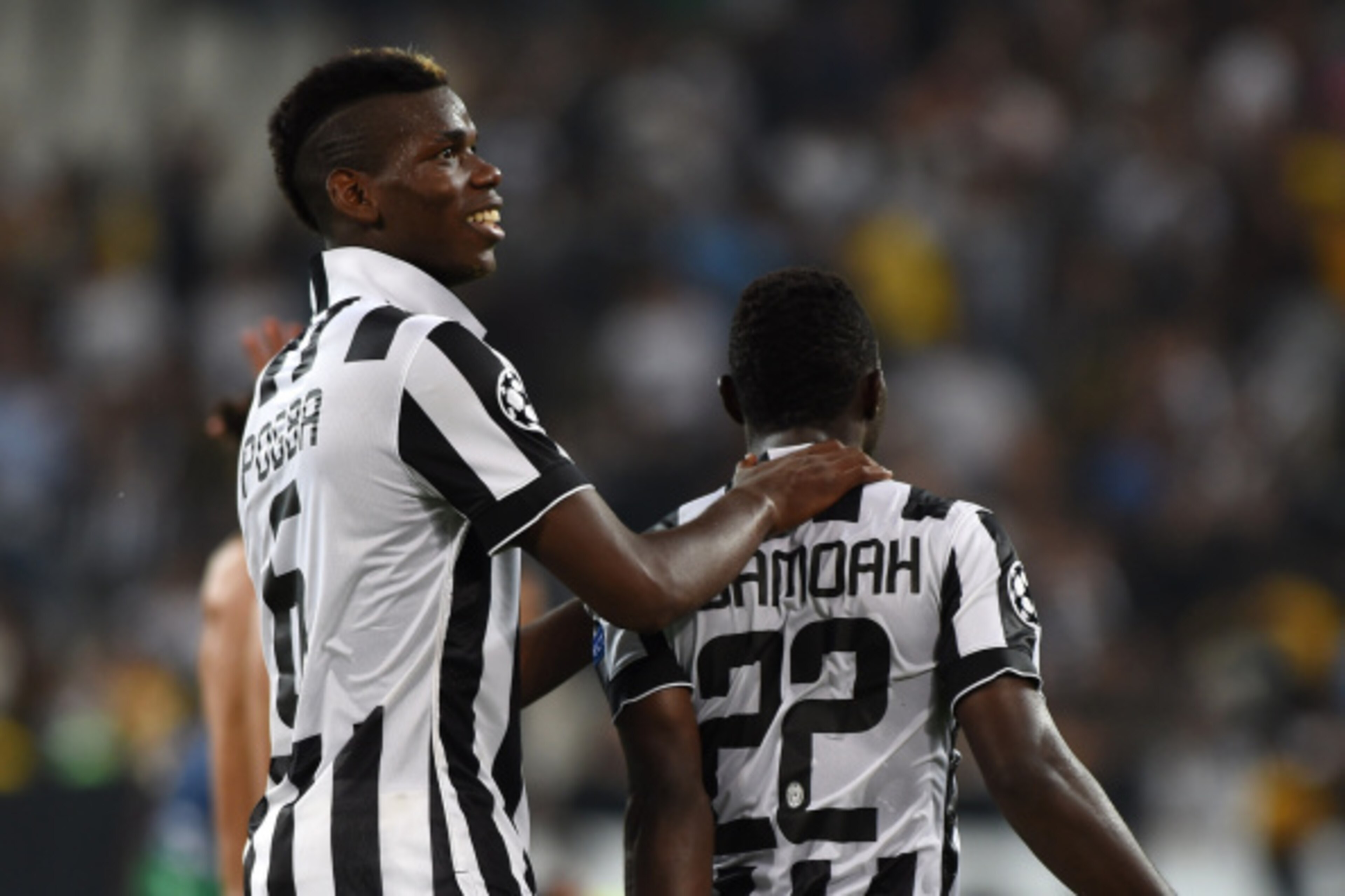TURIN, ITALY - SEPTEMBER 16:  Paul Pogba (L) of Juventus celebrate victory with Kwadwo Asamoah at the end of the UEFA Champions League Group A match between Juventus and Malmo FF on September 16, 2014 in Turin, Italy.  (Photo by Valerio Pennicino/Getty Im