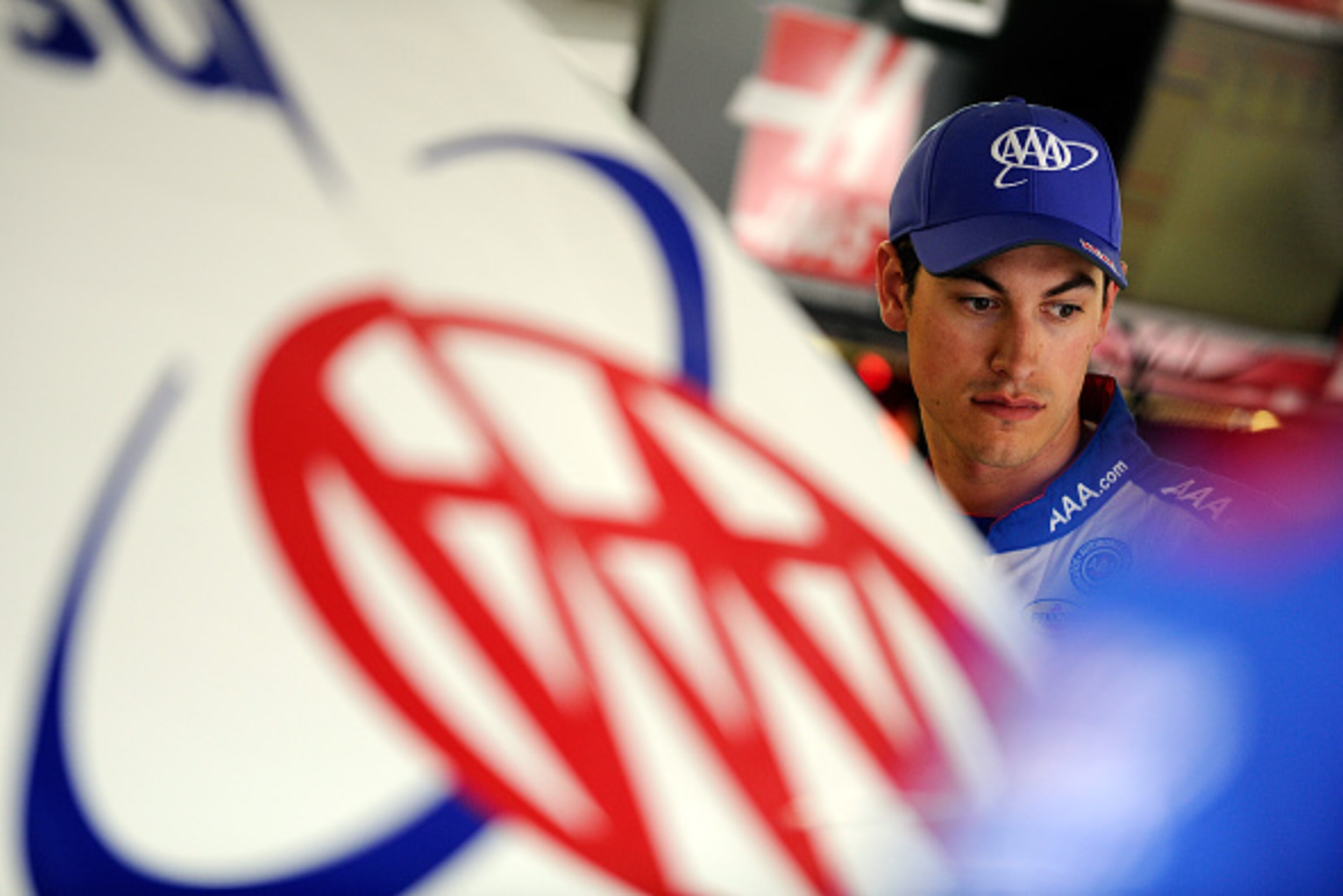 KANSAS CITY, KS - MAY 08:  Joey Logano, driver of the #22 AAA Insurance Ford, stands in the garage area during practice for the NASCAR Sprint Cup Series SpongeBob SquarePants 400 at Kansas Speedway on May 8, 2015 in Kansas City, Kansas.  (Photo by Ed Zurg